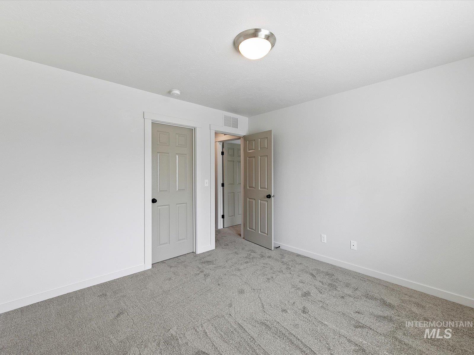 Unfurnished bedroom featuring carpet and baseboards