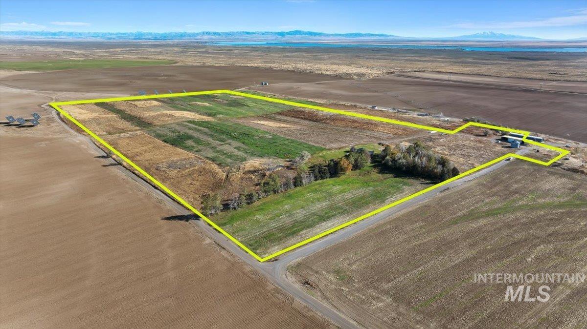 Overview of rural landscape featuring a mountainous background and property parcel outlined