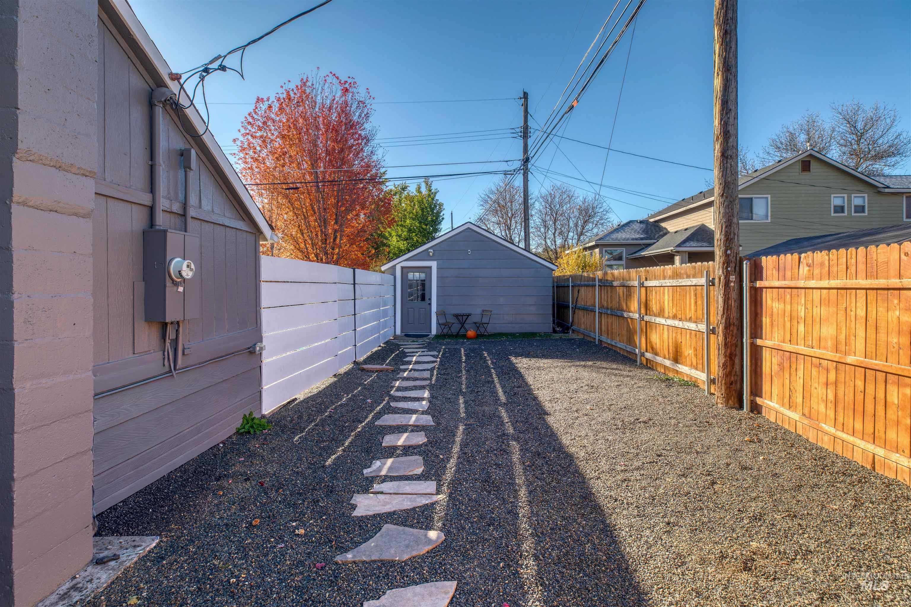 Fenced backyard with an outbuilding