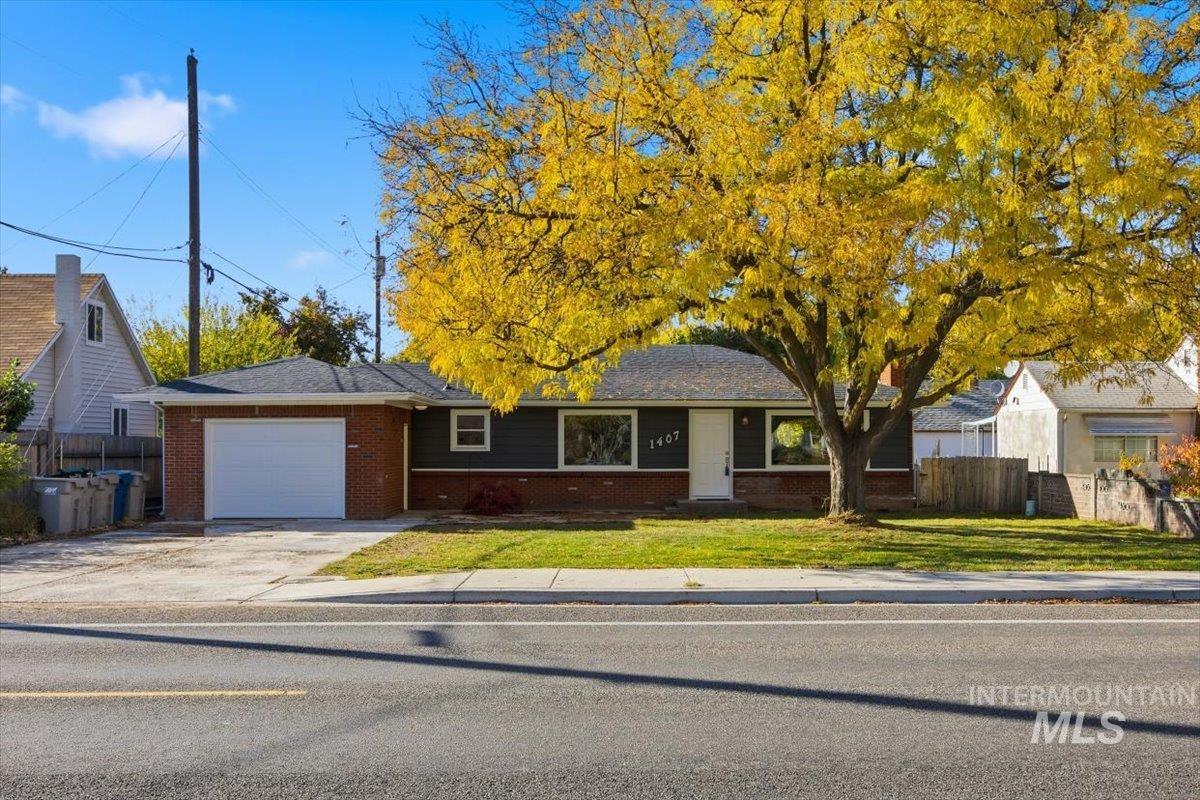 Ranch-style home with a garage, concrete driveway, and brick siding