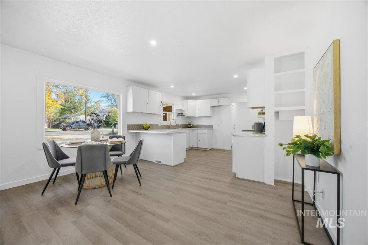 Kitchen featuring white cabinets, light wood-style floors, and recessed lighting