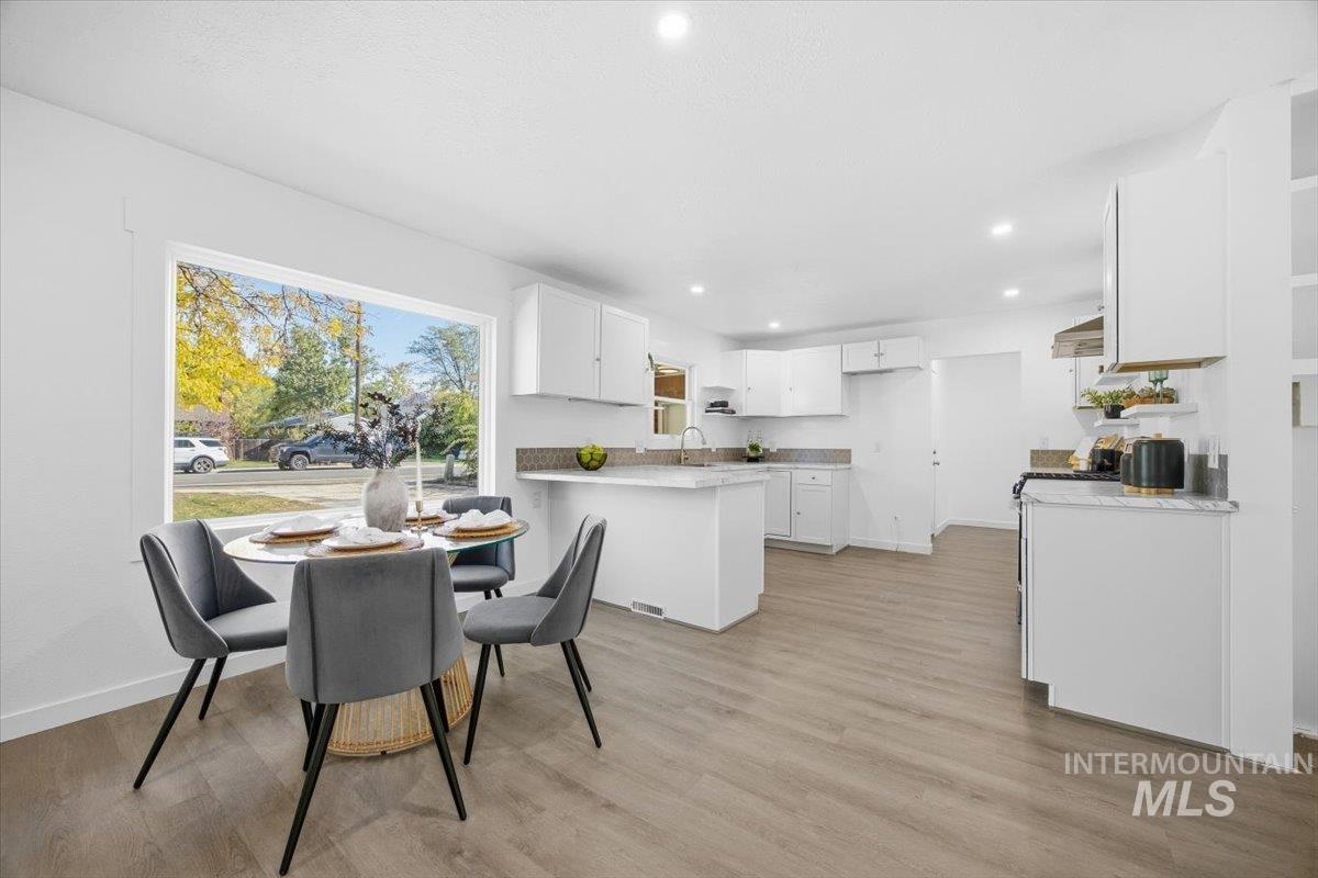 Dining area featuring light wood-style flooring and recessed lighting