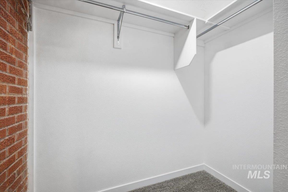 Spacious closet with carpet flooring