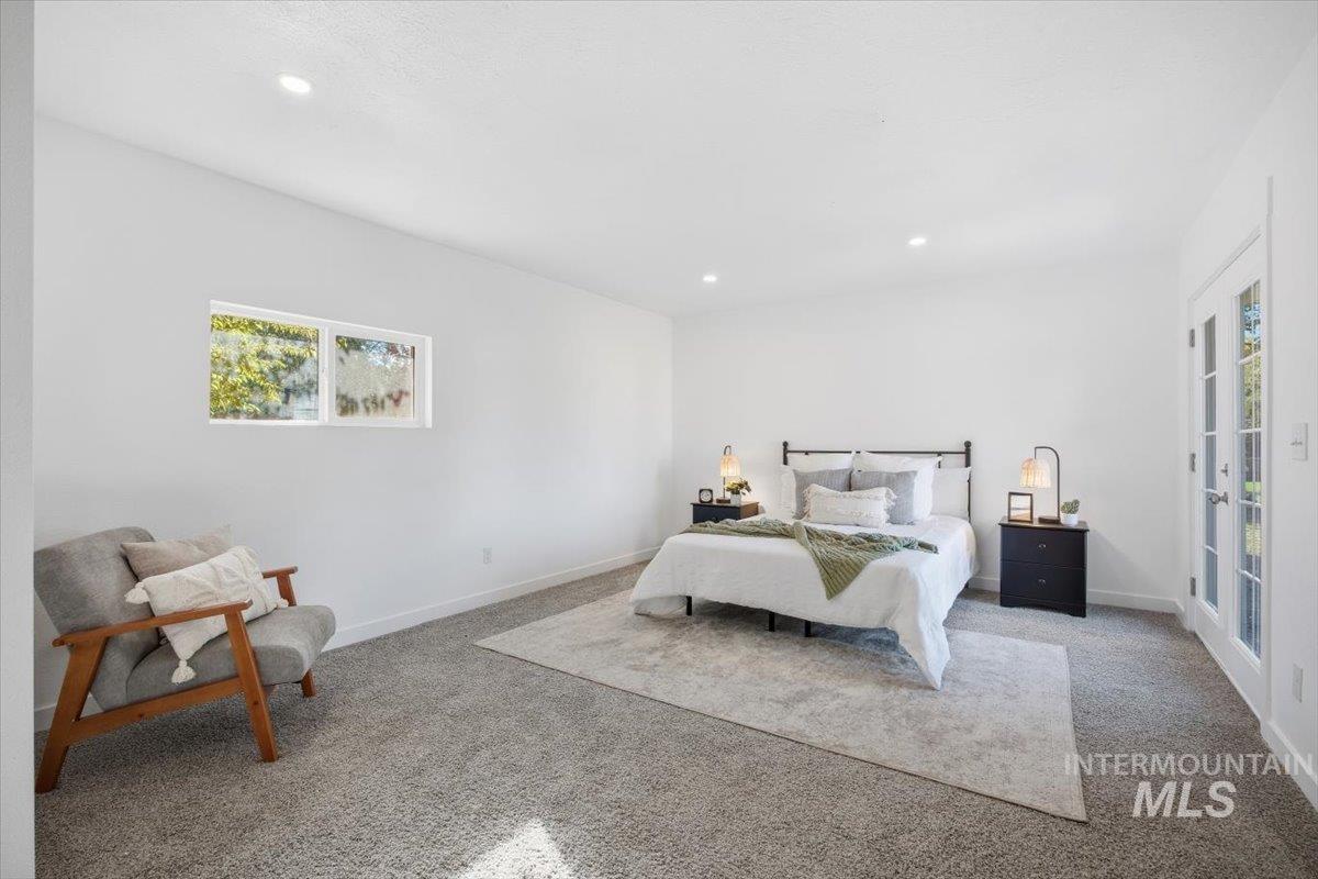 Bedroom featuring carpet flooring, multiple windows, and recessed lighting