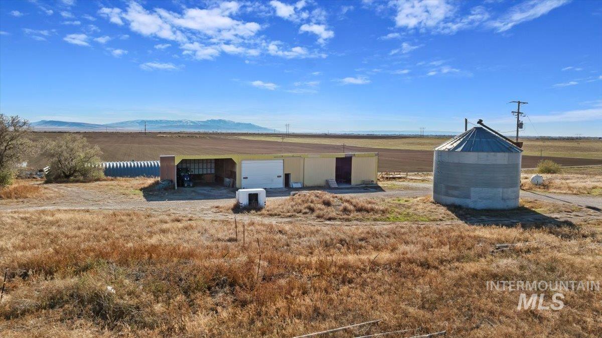 View of pole building featuring a rural view and a mountain view
