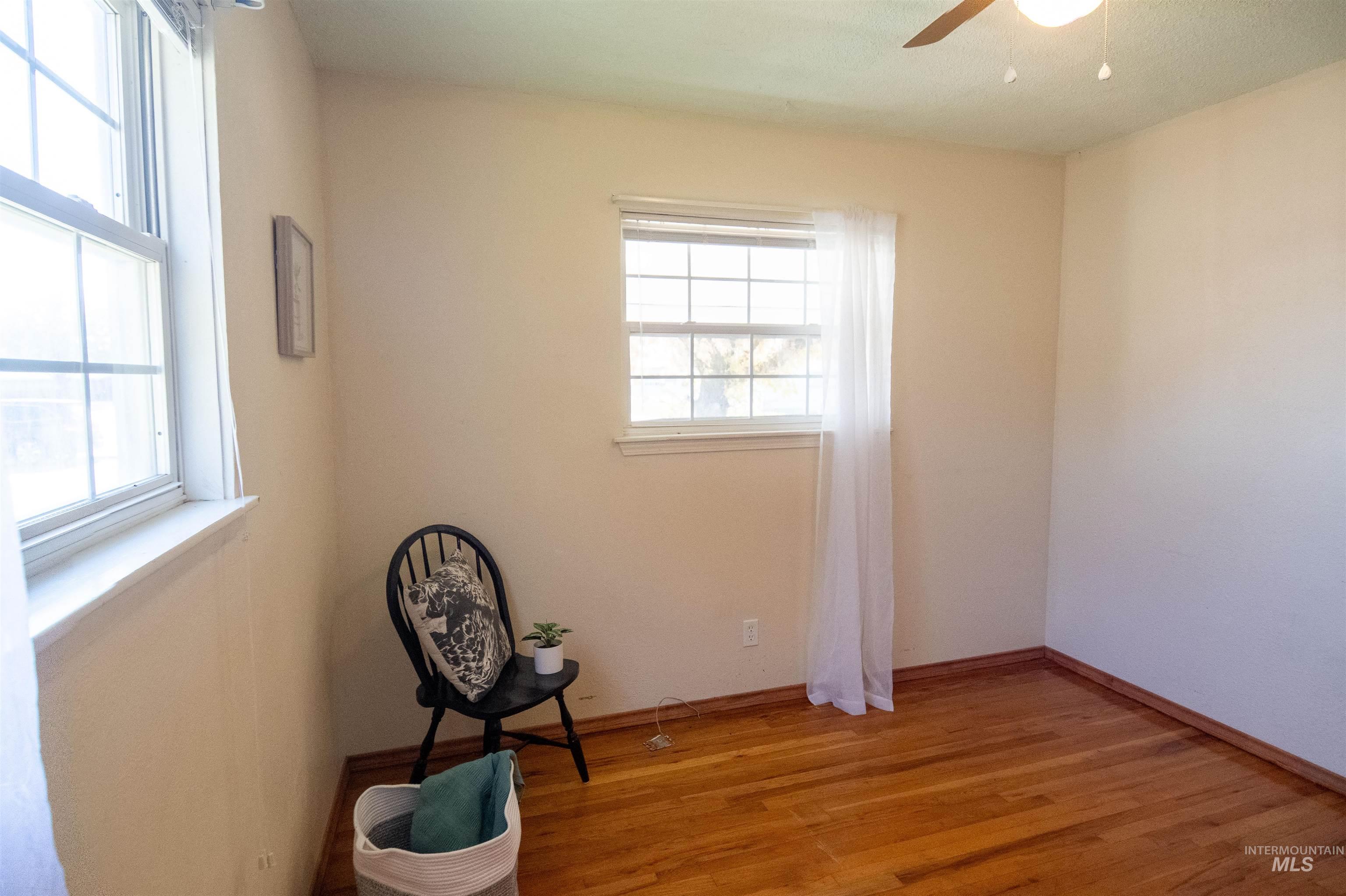 Spare room with light wood-style floors and a ceiling fan