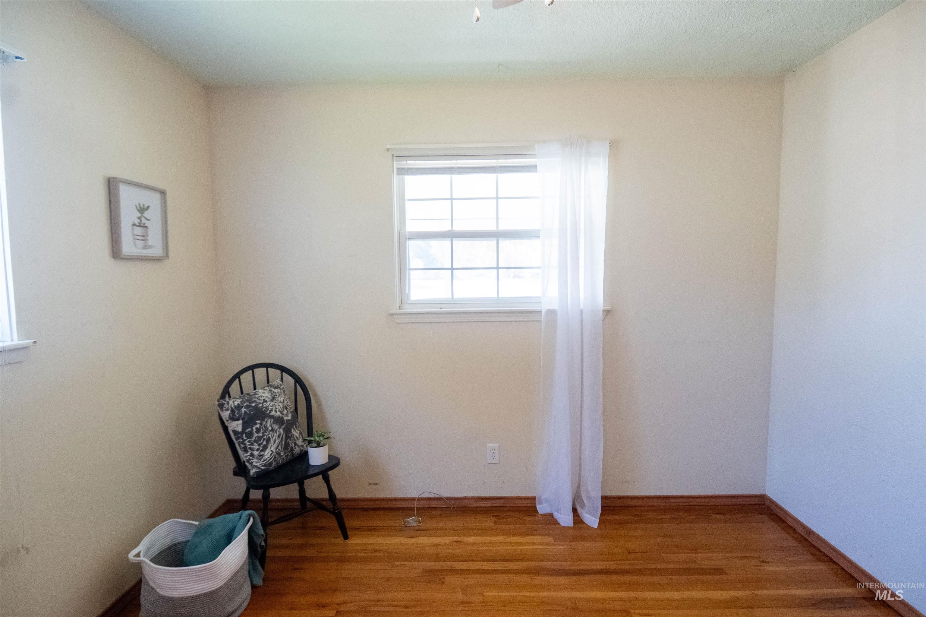 Unfurnished room with light wood-type flooring and baseboards