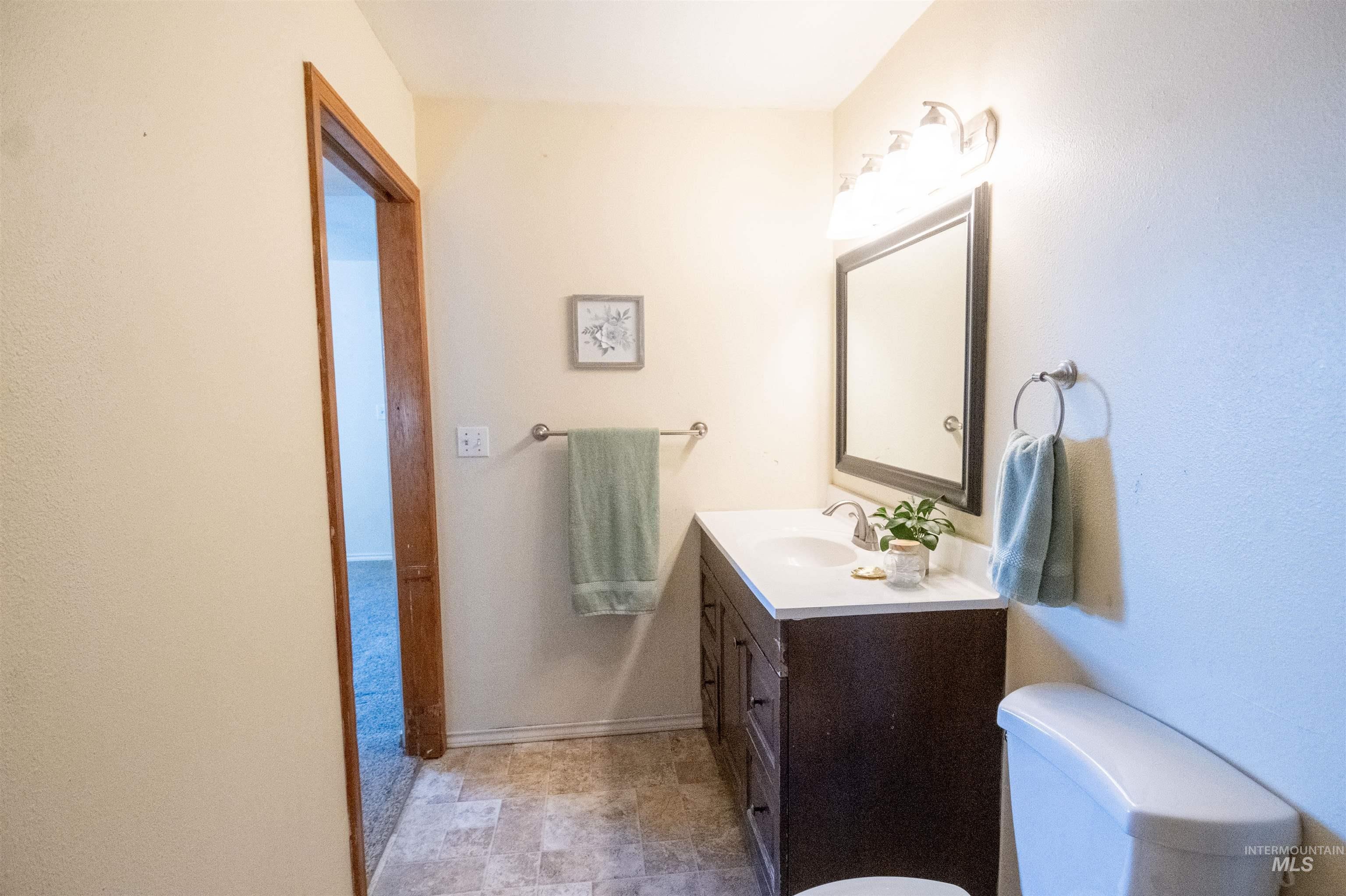 Bathroom featuring vanity and toilet