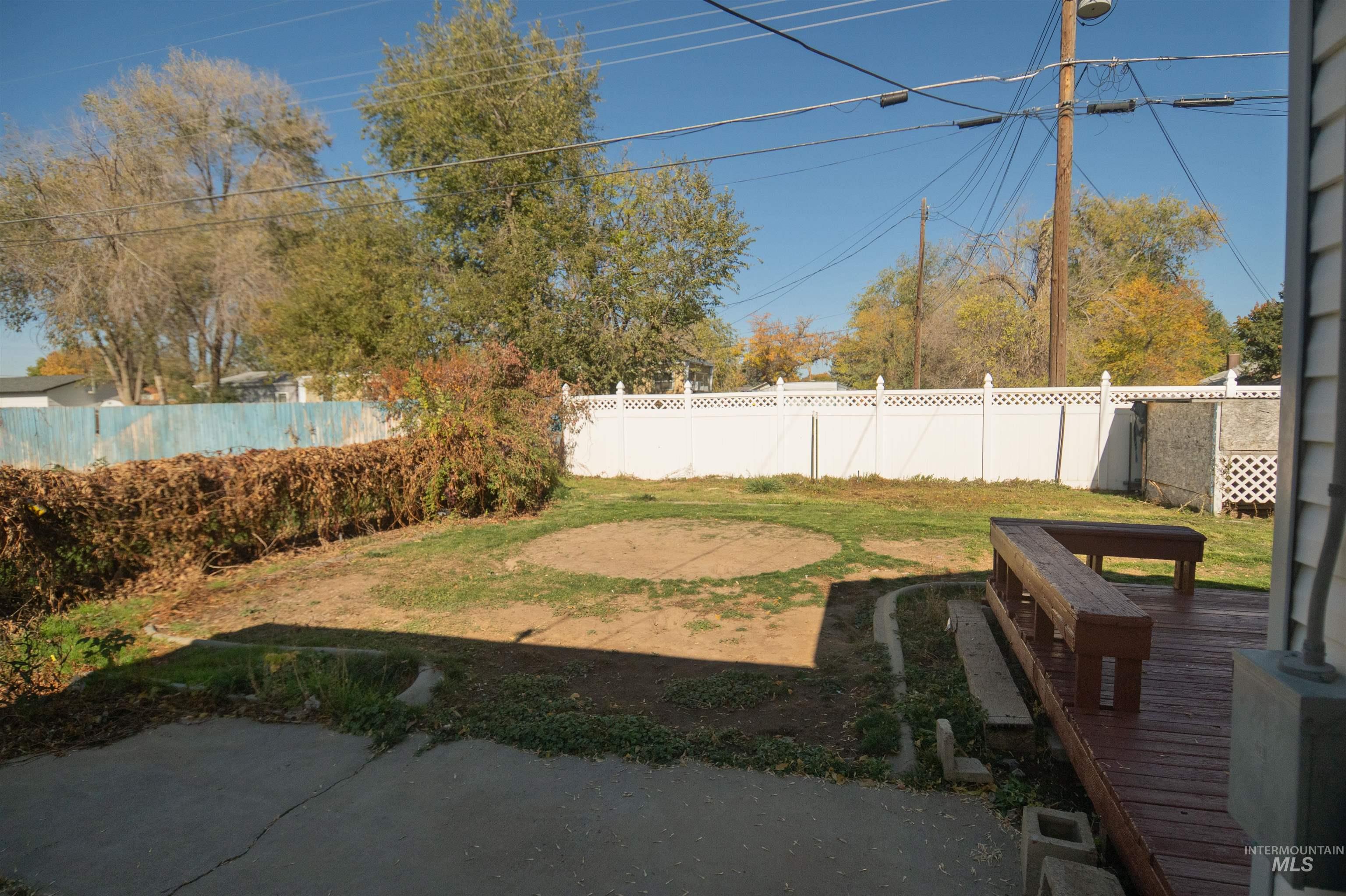 Fenced backyard with a deck