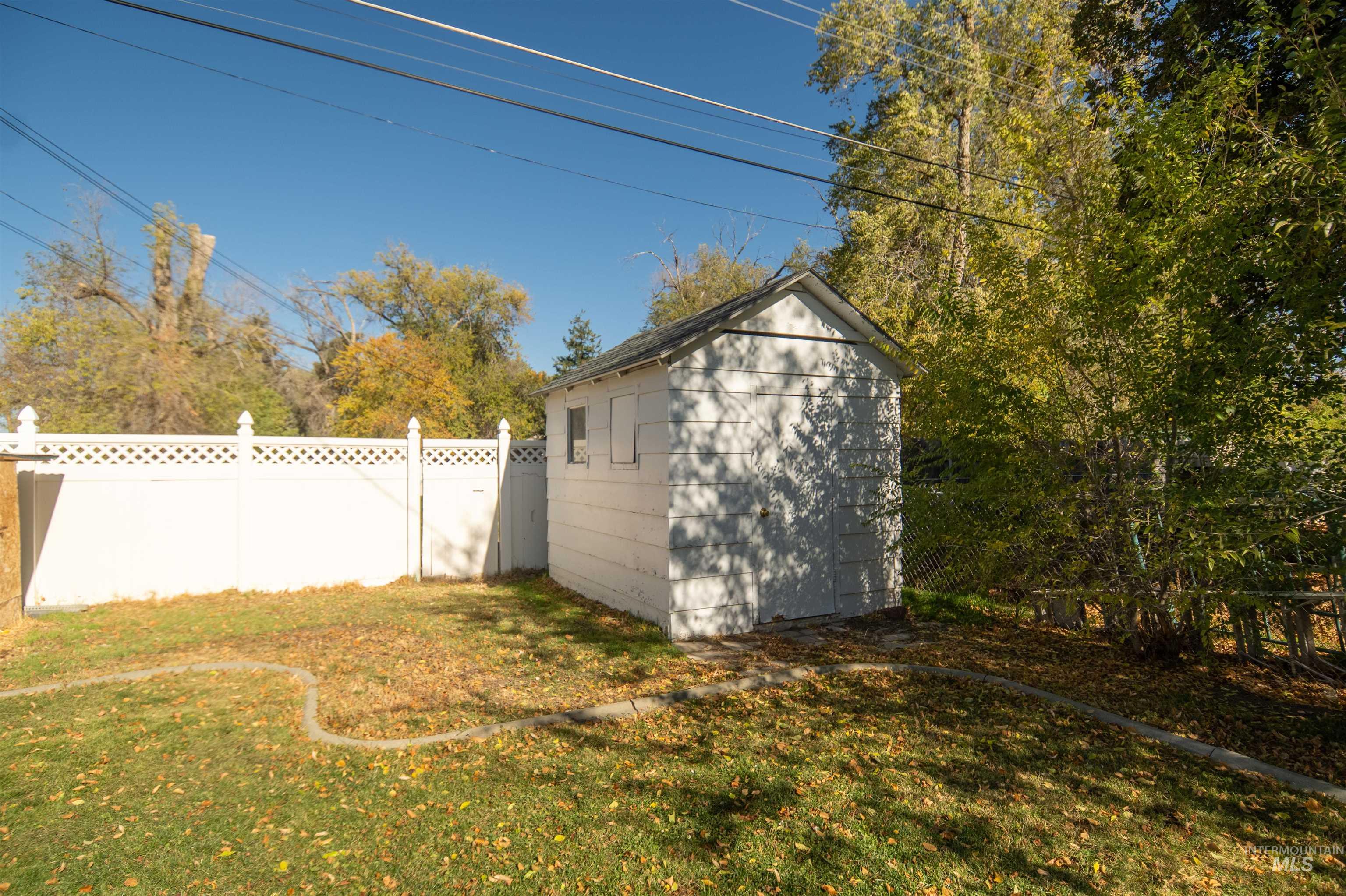 View of yard with a storage unit