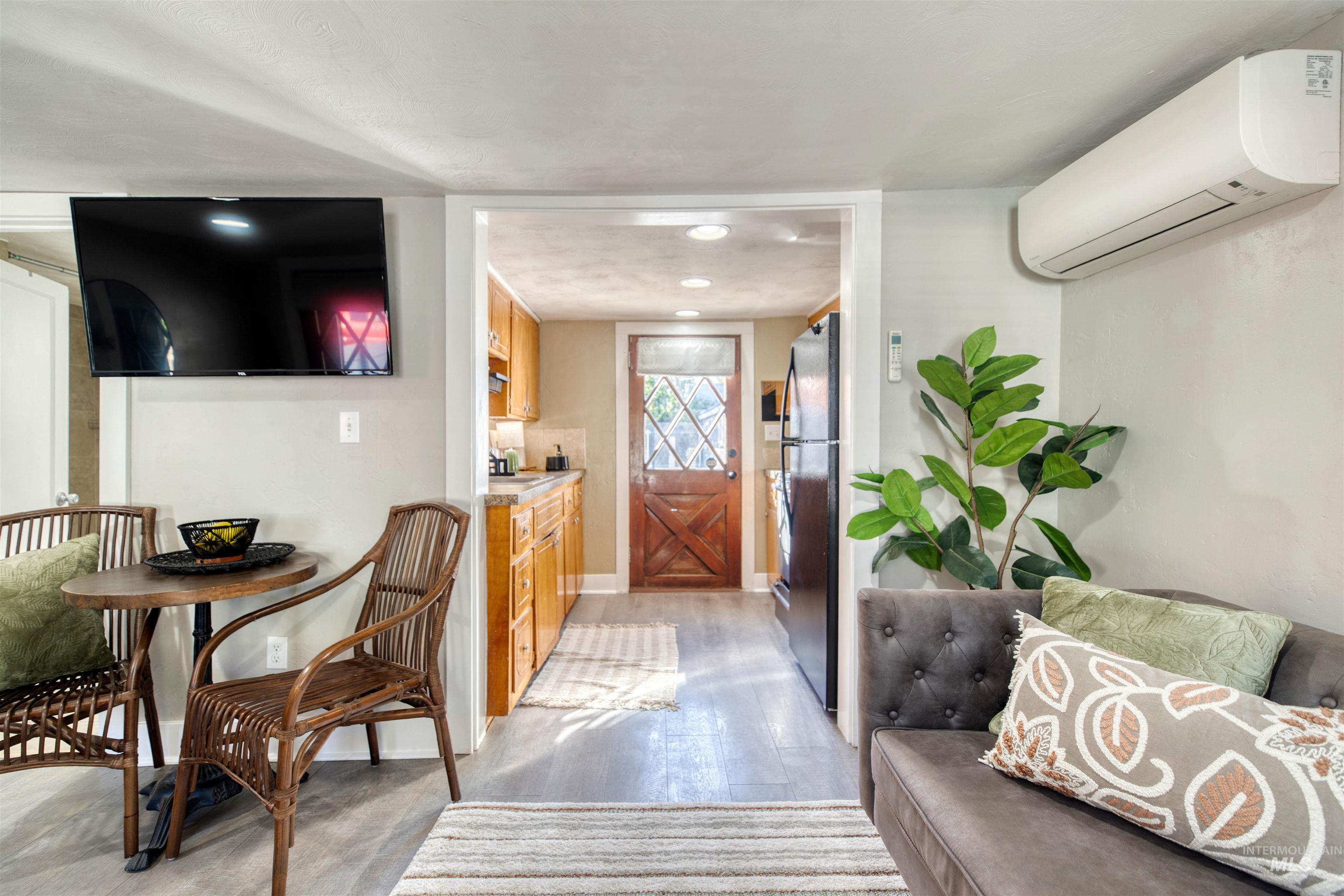 Entrance foyer featuring a wall mounted AC and light wood finished floors