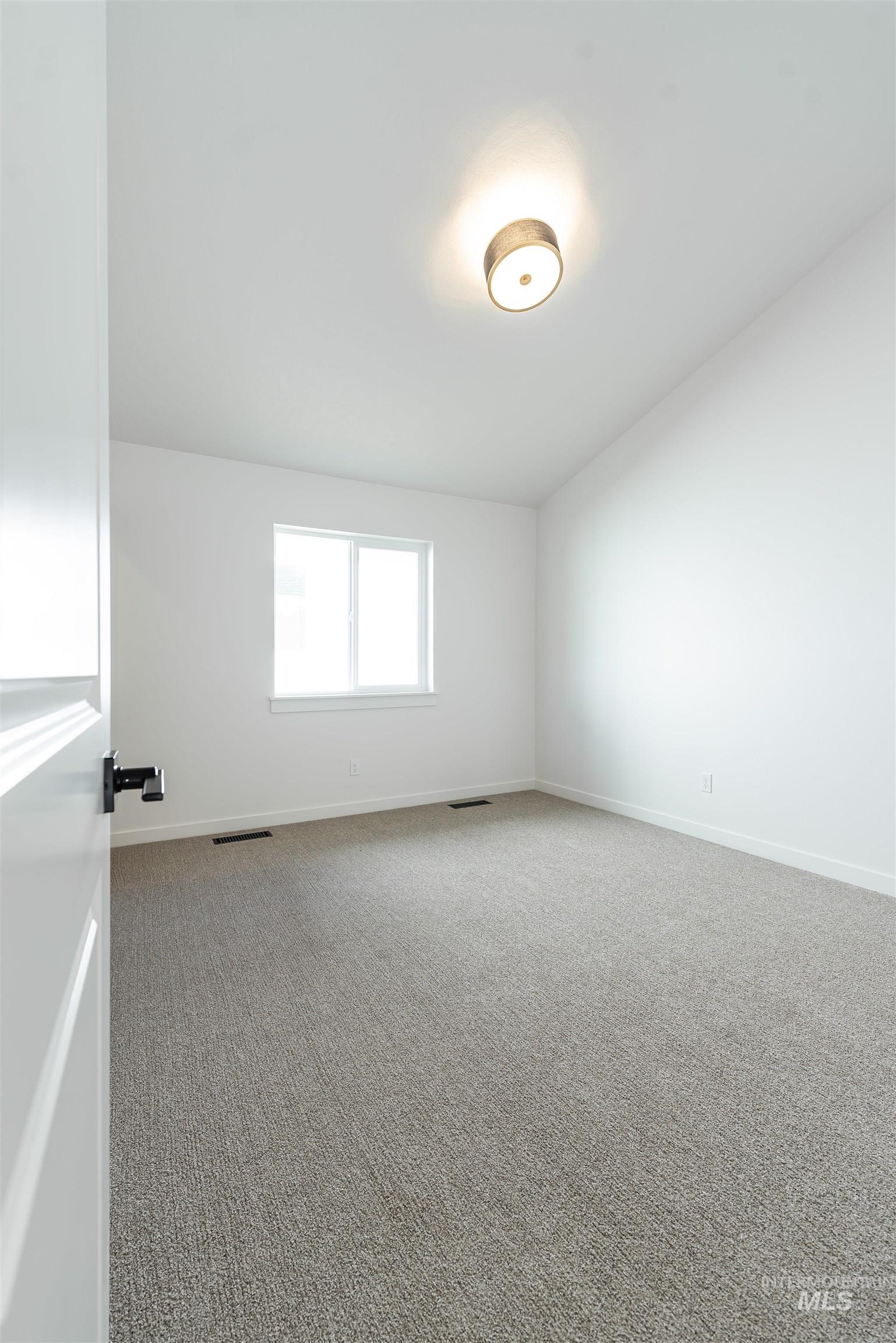 Unfurnished room with carpet and baseboards