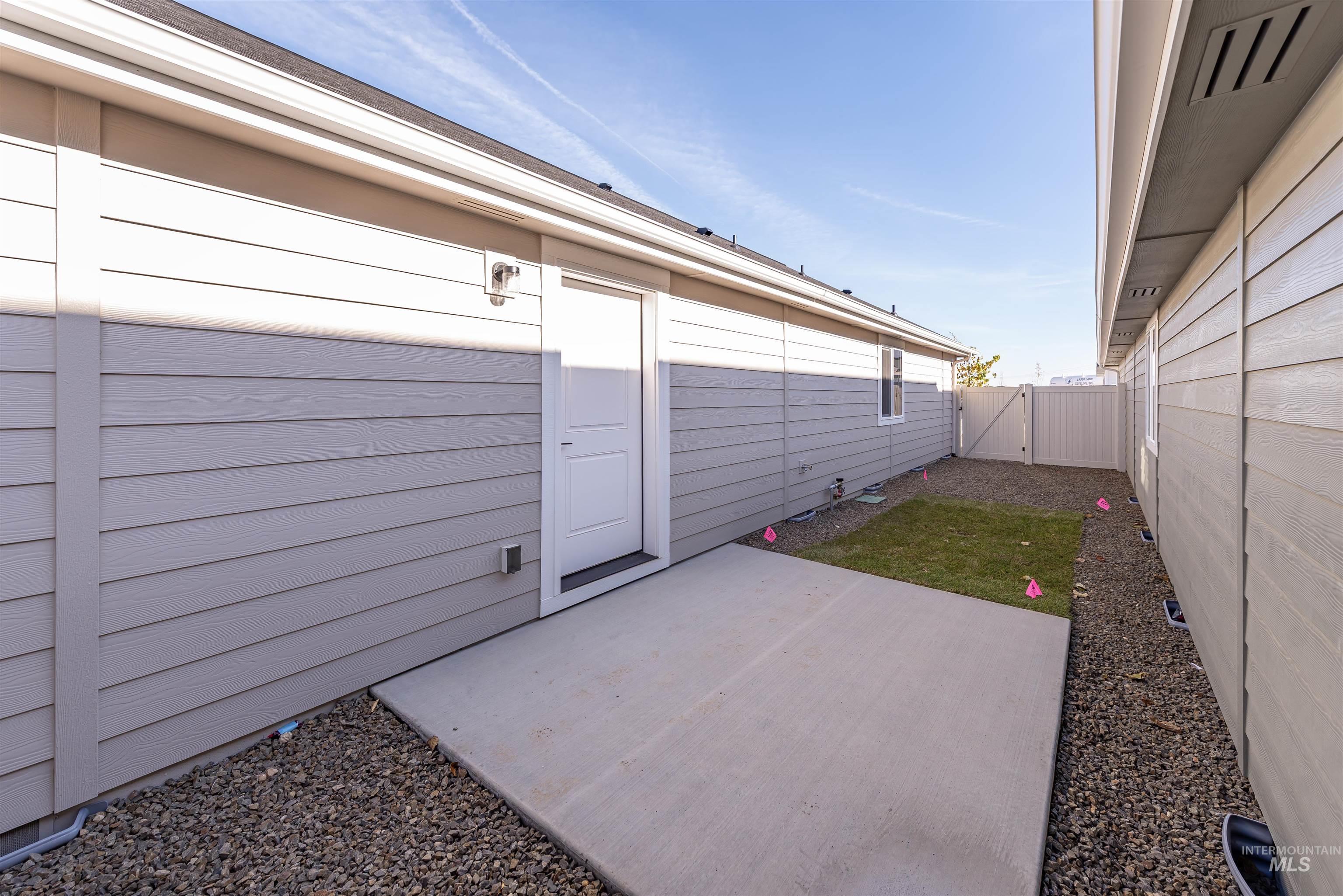 Fenced backyard with a patio area and a gate