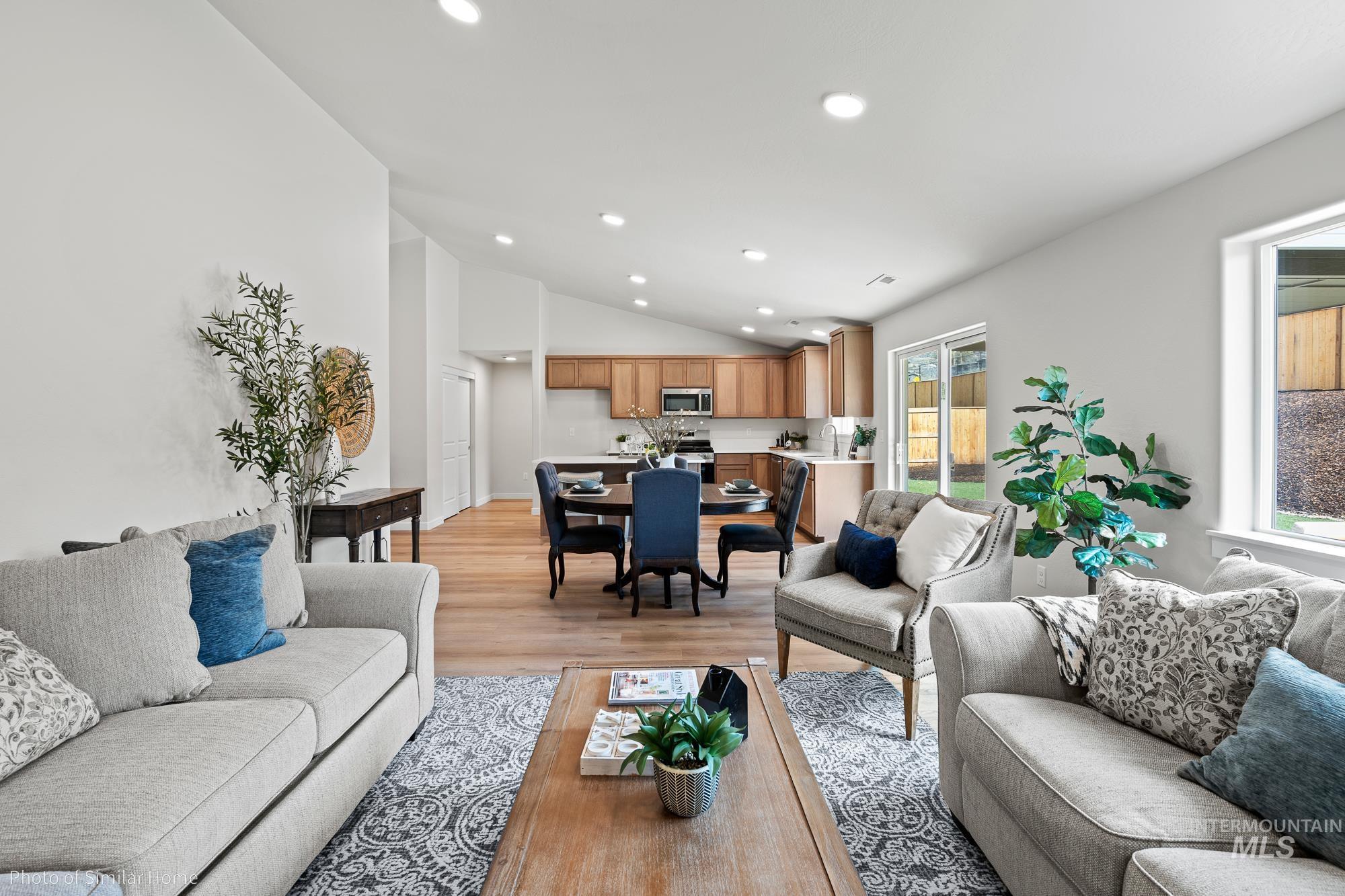 Living room featuring recessed lighting, light wood-style flooring, and lofted ceiling