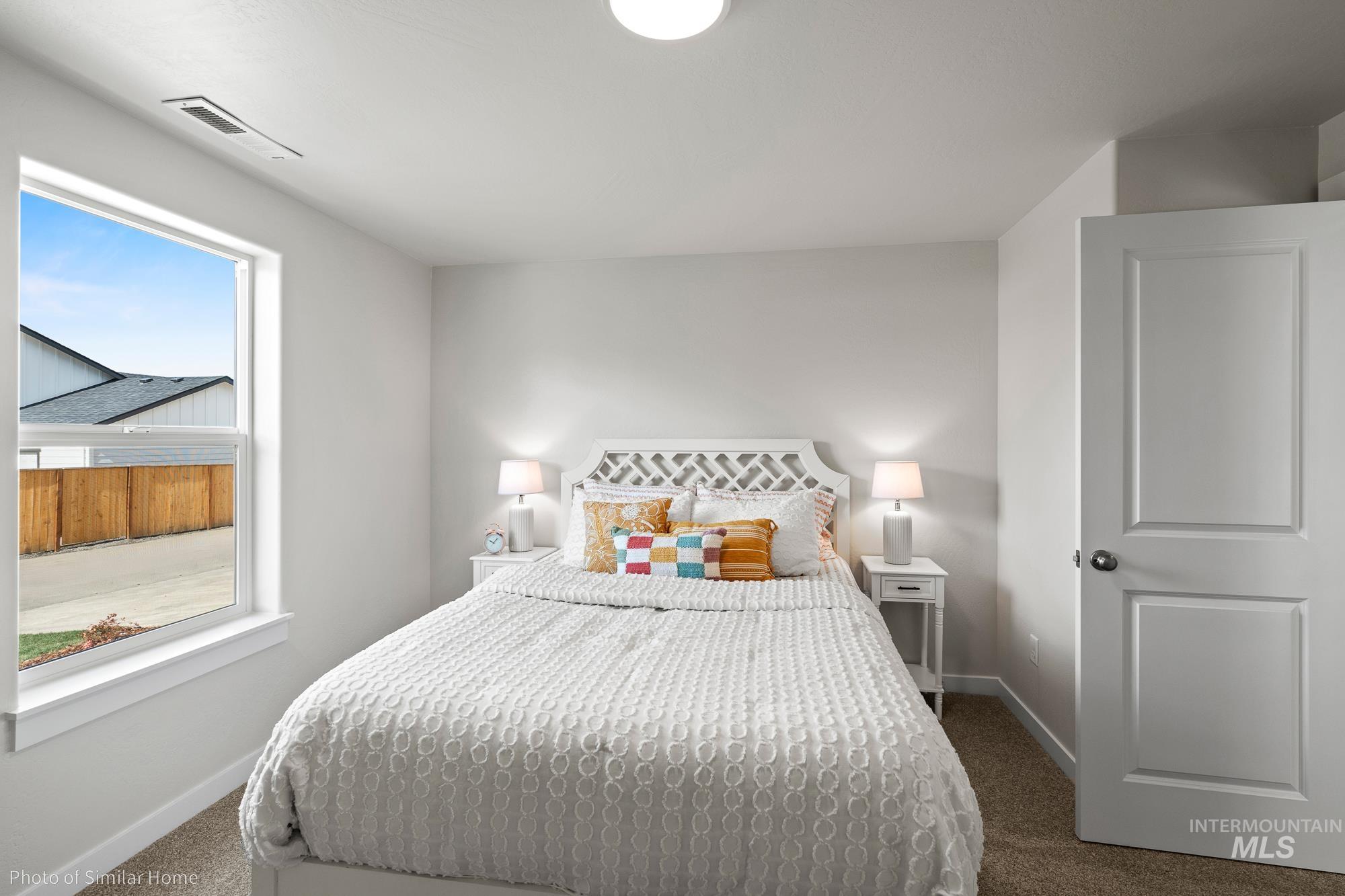 Bedroom with carpet flooring and baseboards