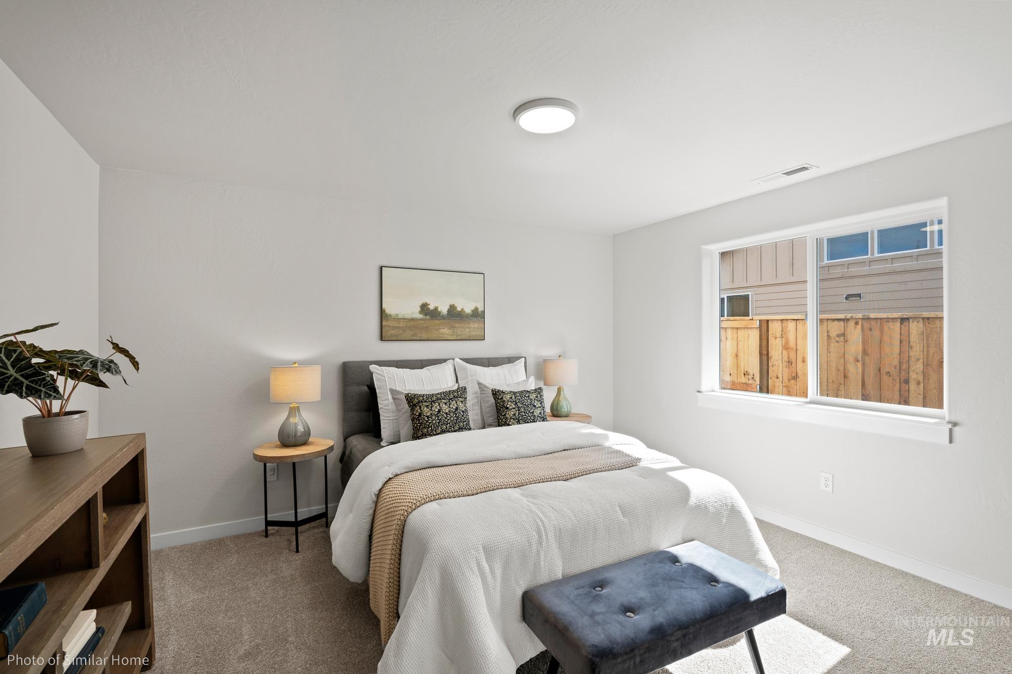 Bedroom with carpet flooring and baseboards