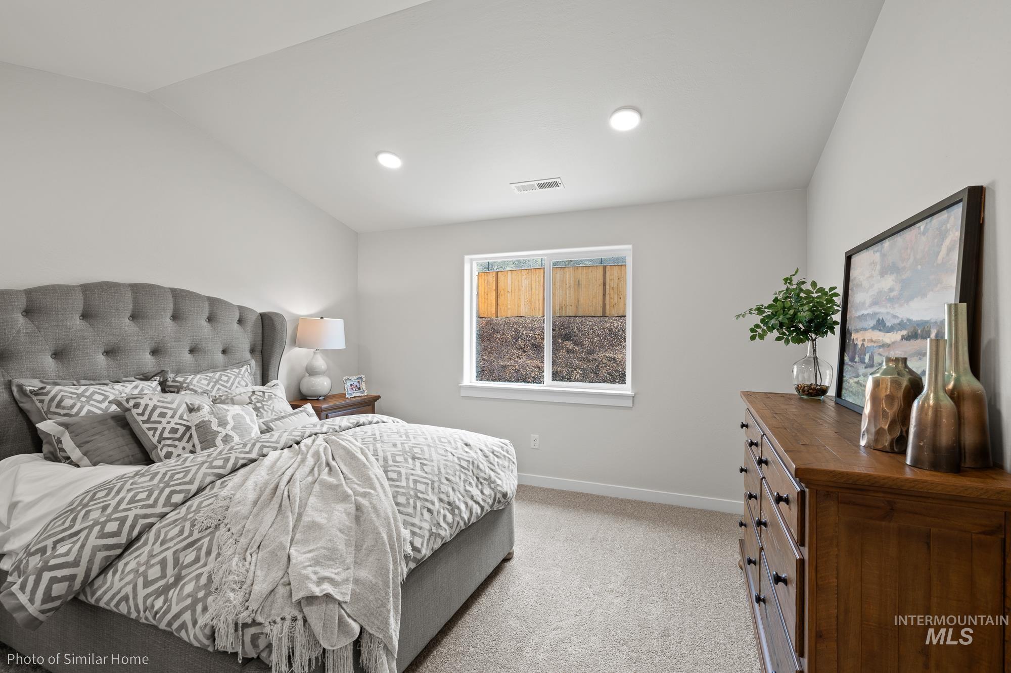 Bedroom featuring light carpet, recessed lighting, and lofted ceiling