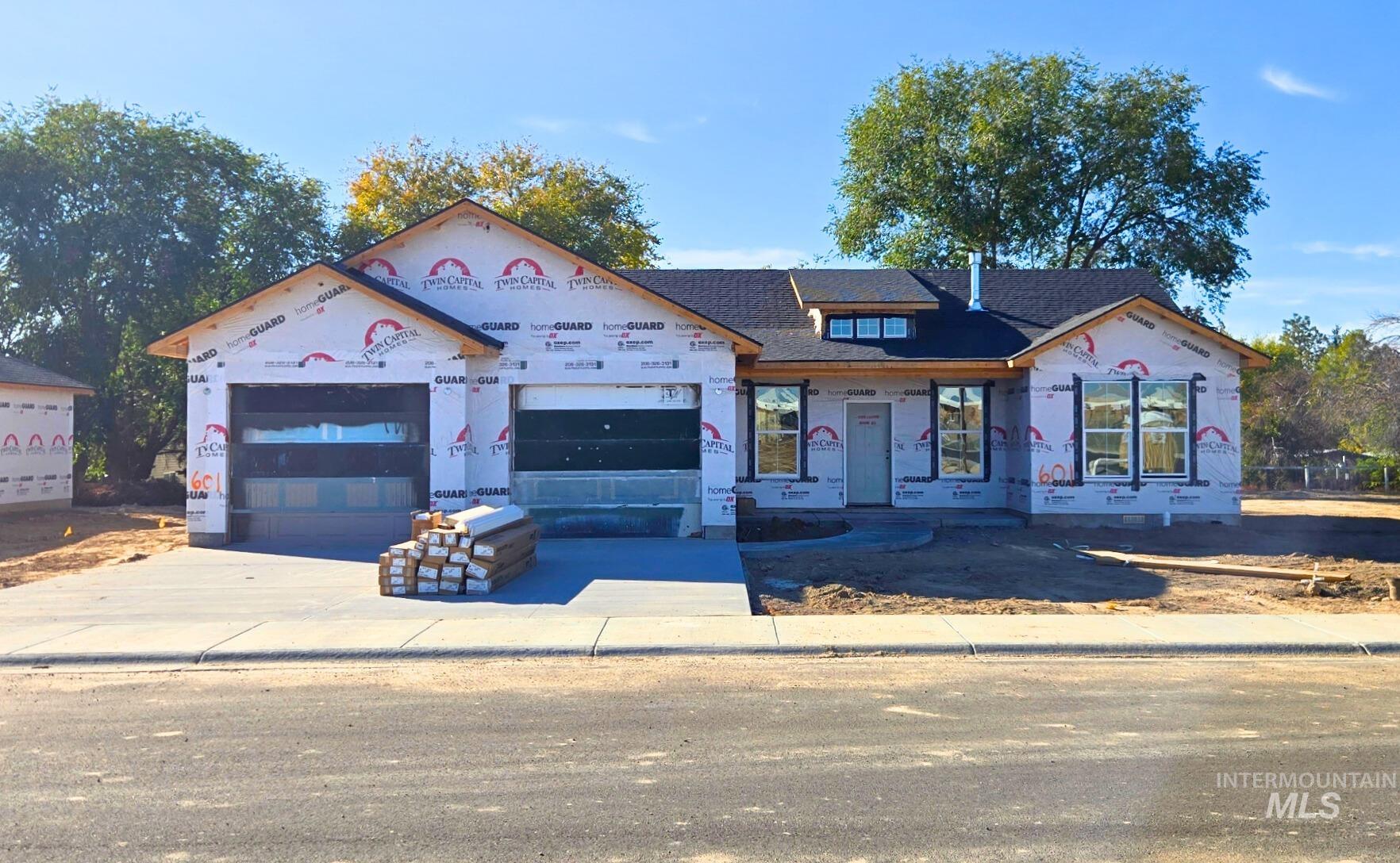 Property in mid-construction with concrete driveway and a garage