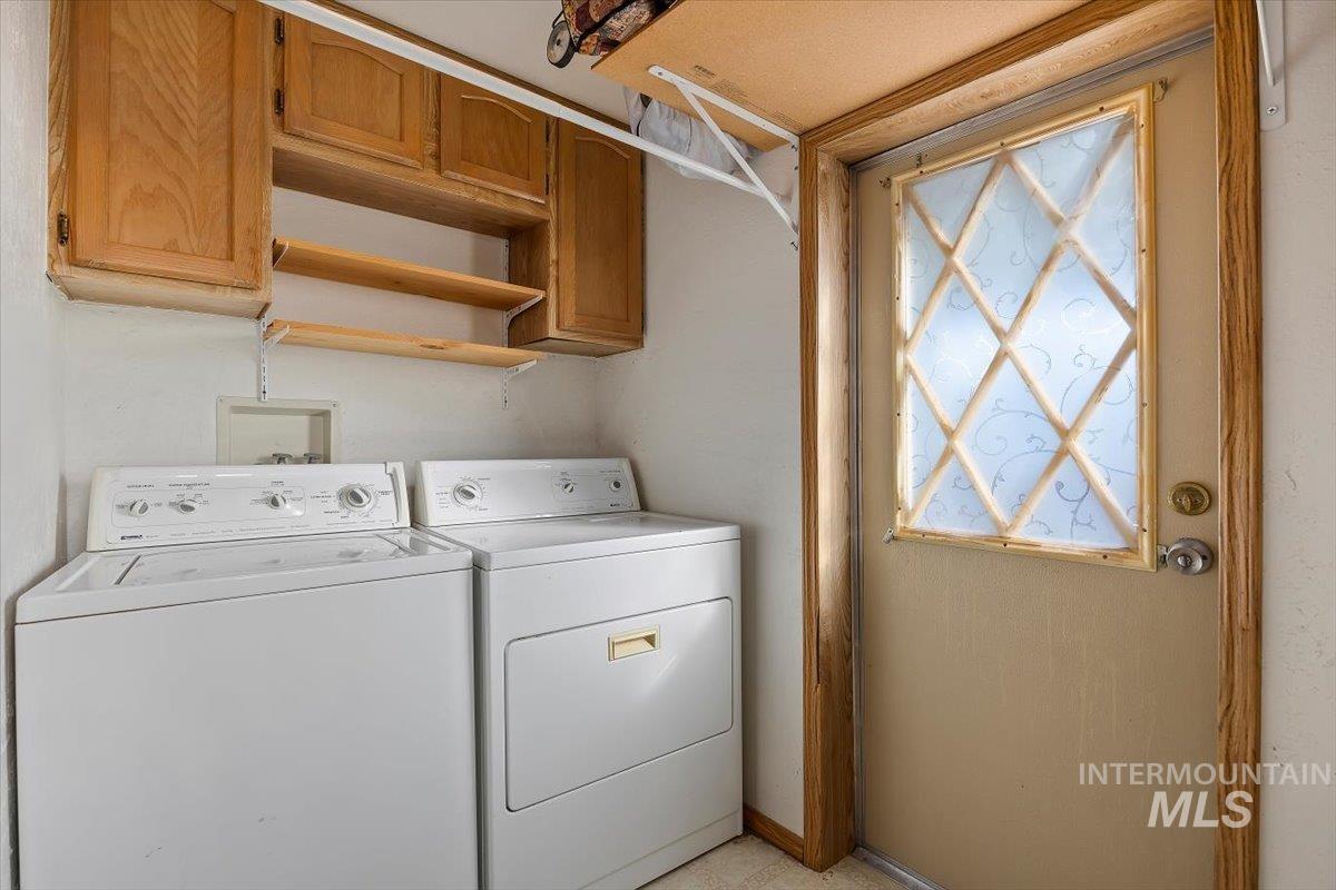 Laundry room featuring cabinet space and separate washer and dryer