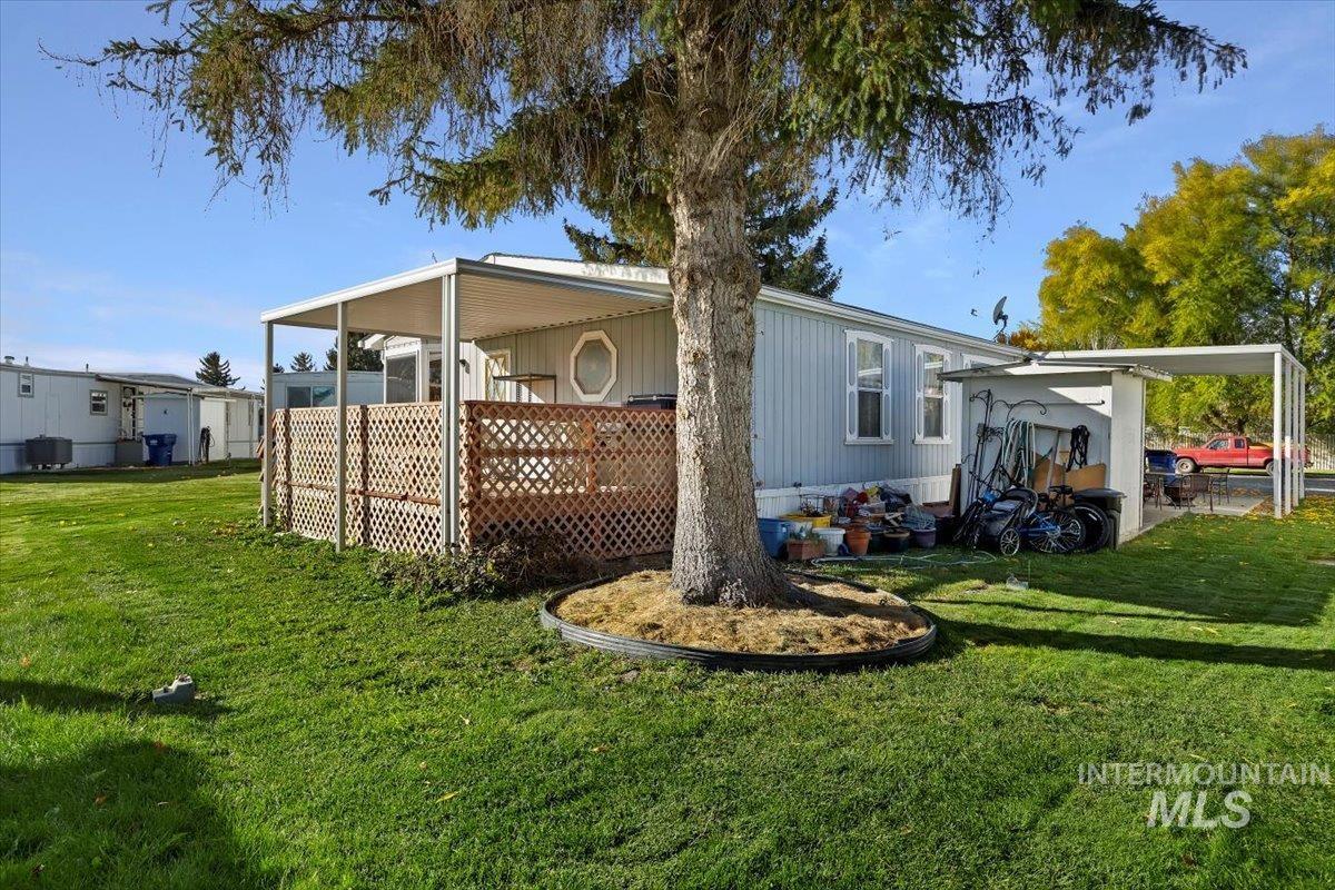 Rear view of house with a lawn and a wooden deck