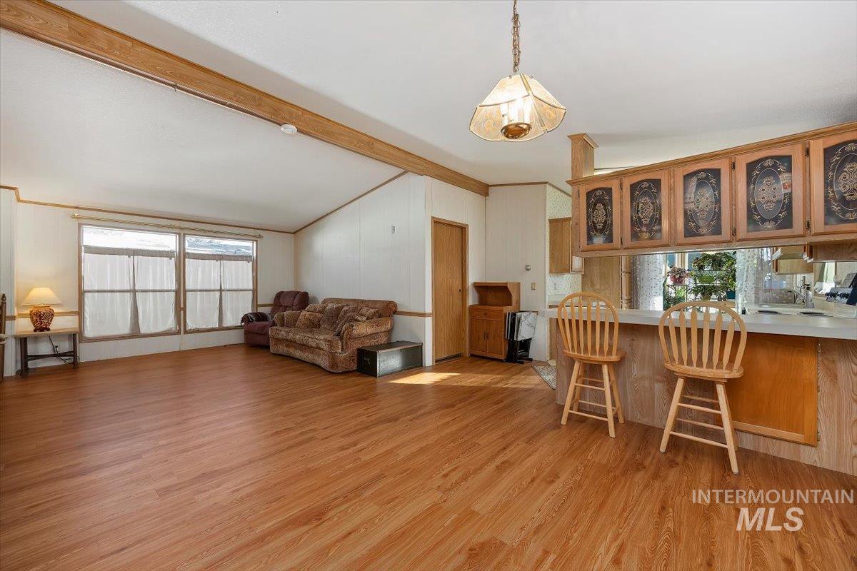 Dining area with light wood-style floors and crown molding
