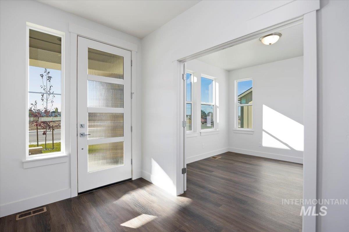 Entryway featuring wood finished floors and baseboards