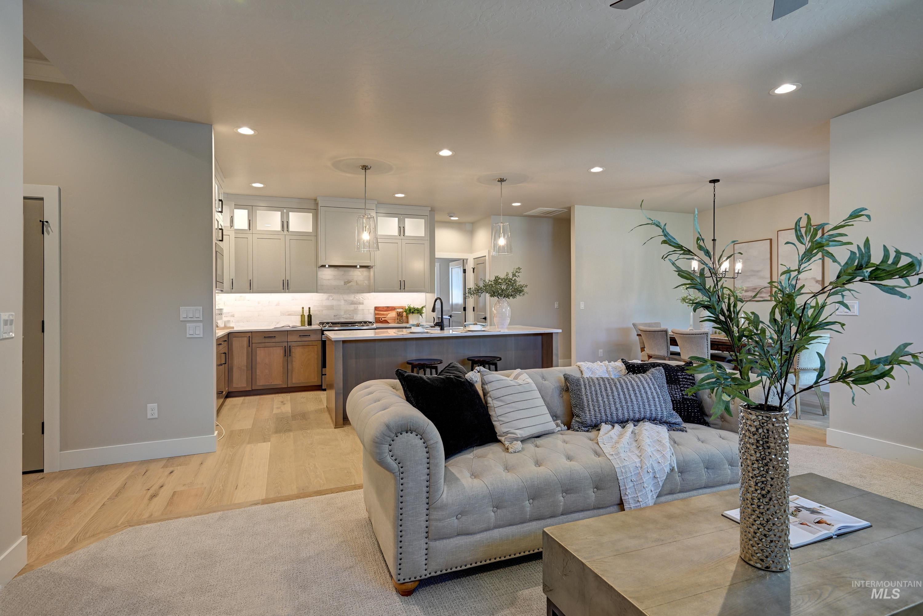 Living room featuring recessed lighting, light wood finished floors, and ceiling fan