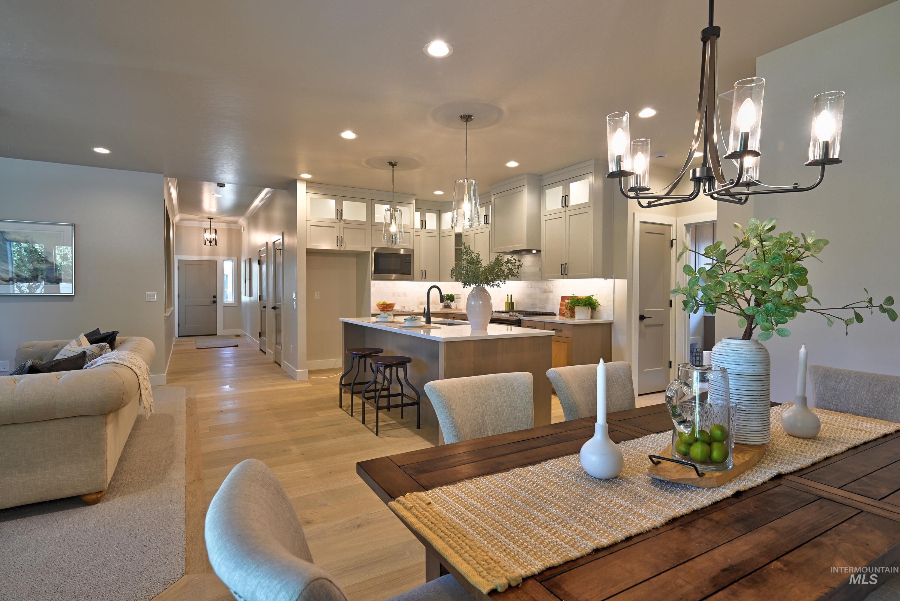Dining area with a chandelier, recessed lighting, and light wood-type flooring