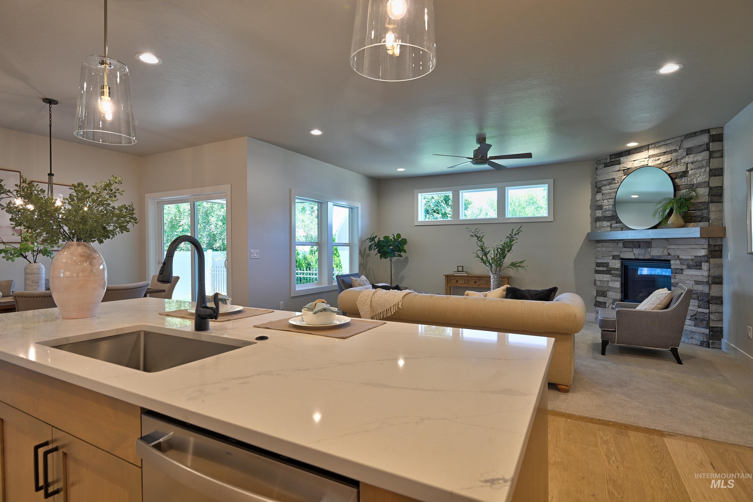 Kitchen with open floor plan, dishwasher, a center island with sink, and recessed lighting