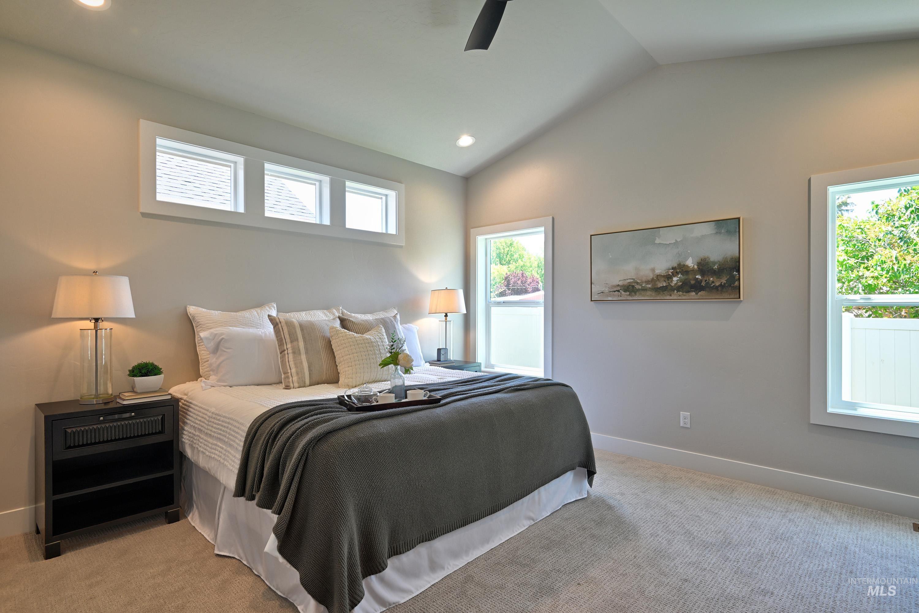 Bedroom with lofted ceiling, light colored carpet, recessed lighting, and ceiling fan