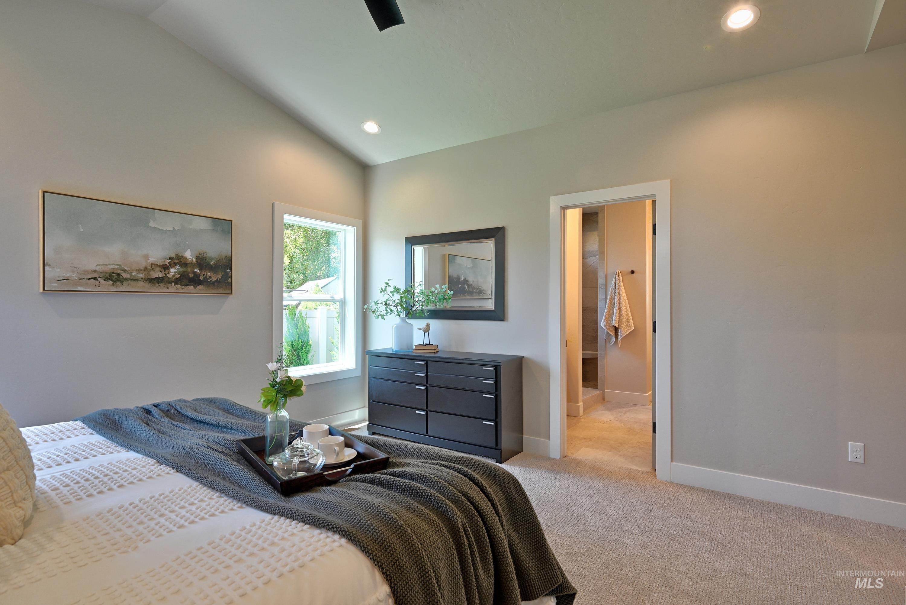 Bedroom with light carpet, lofted ceiling, and recessed lighting