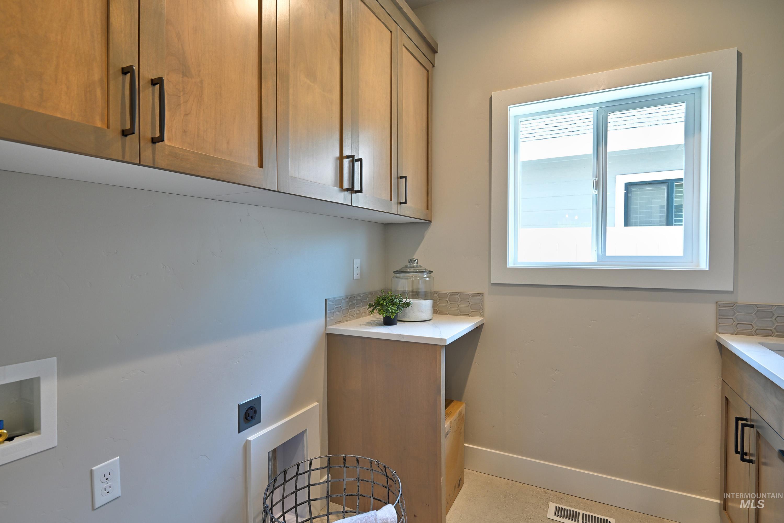 Laundry area featuring hookup for an electric dryer, cabinet space, and hookup for a washing machine