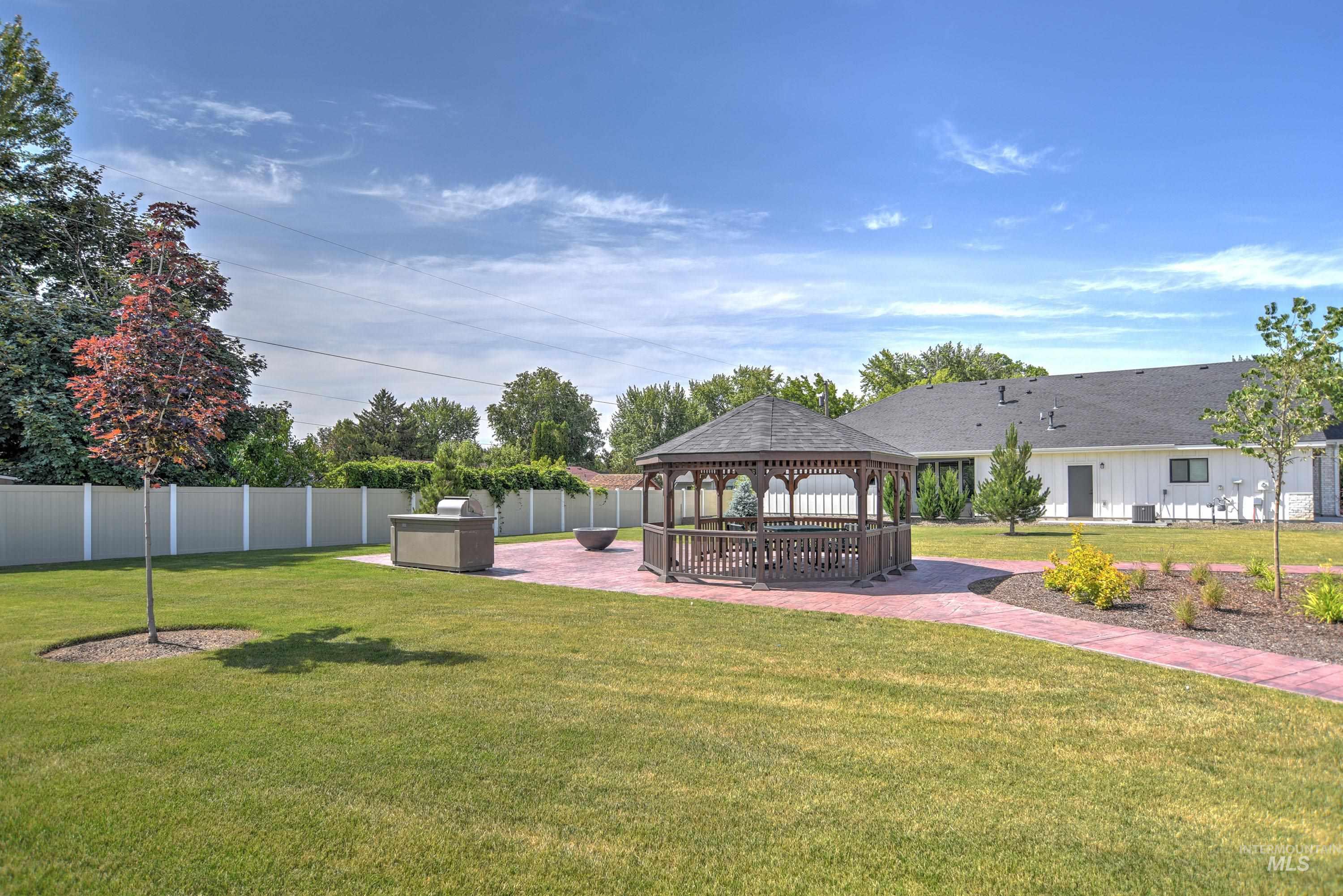 Fenced yard with a gazebo and a patio