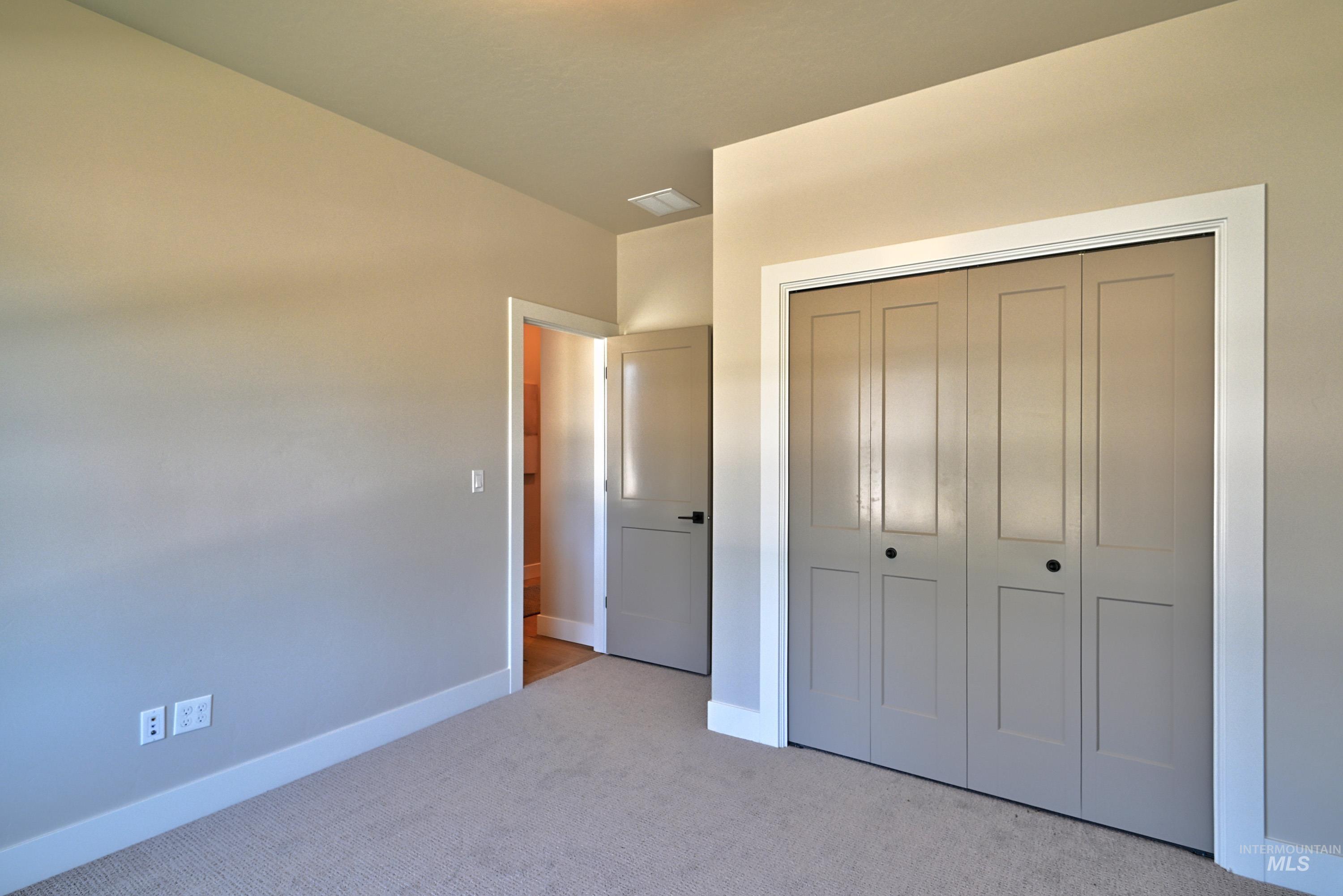 Unfurnished bedroom with carpet floors and a closet