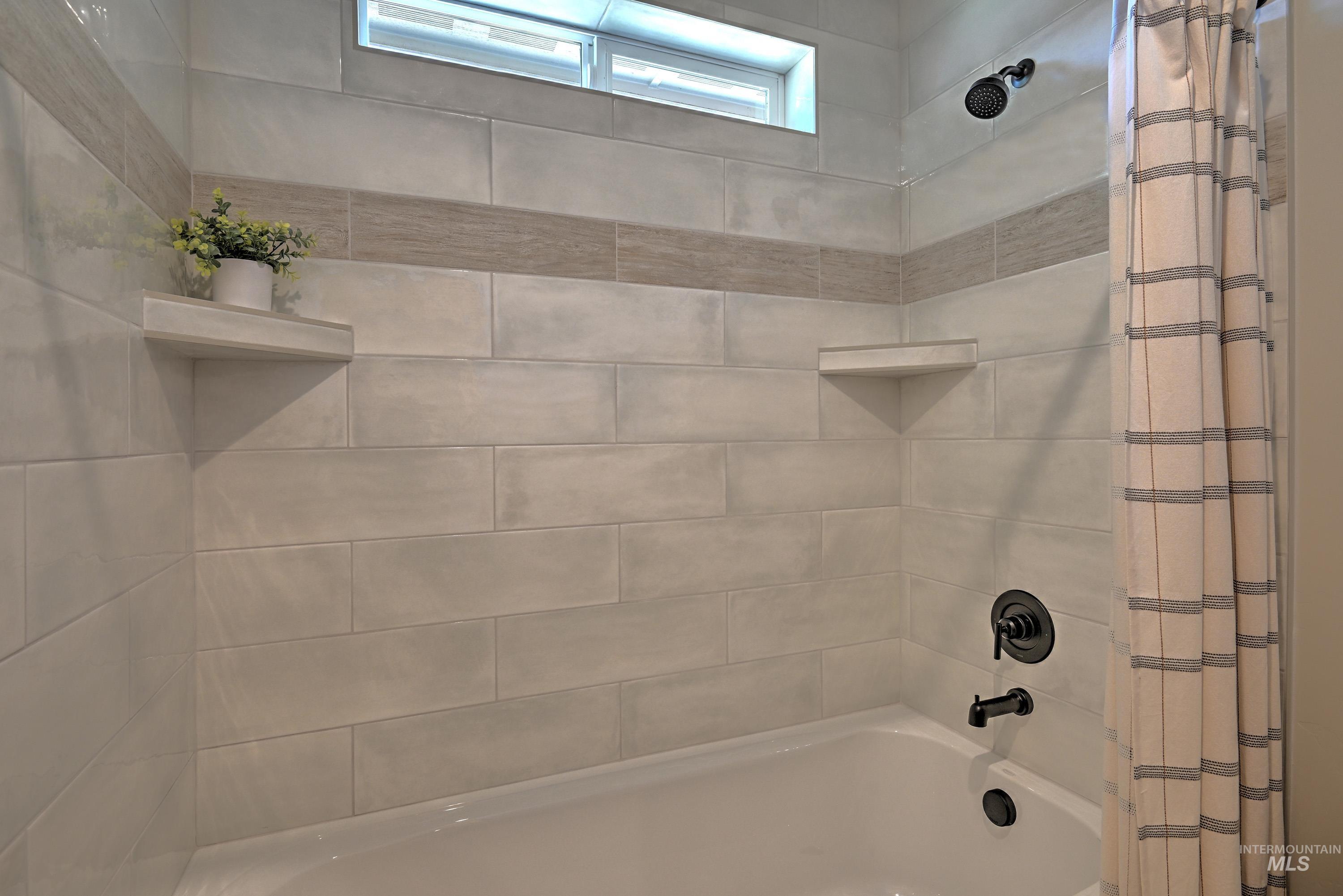 Full bathroom with shower / bath combination with curtain