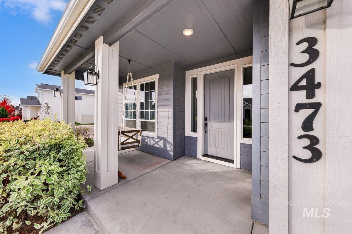 View of exterior entry featuring covered porch