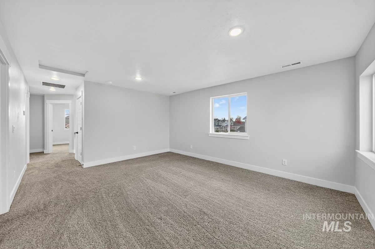 Unfurnished room featuring light colored carpet and recessed lighting
