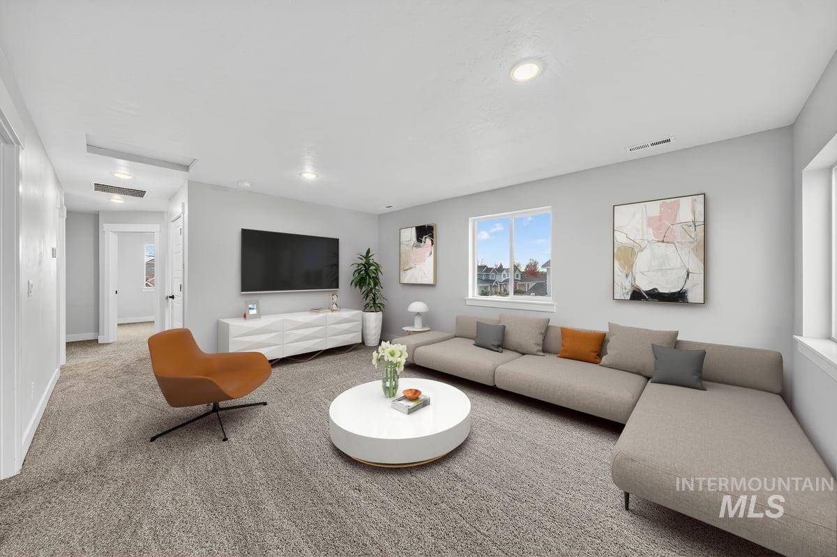 Living room featuring carpet flooring and recessed lighting