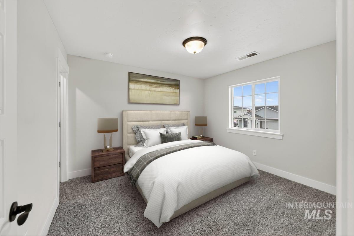 Bedroom featuring carpet flooring and baseboards