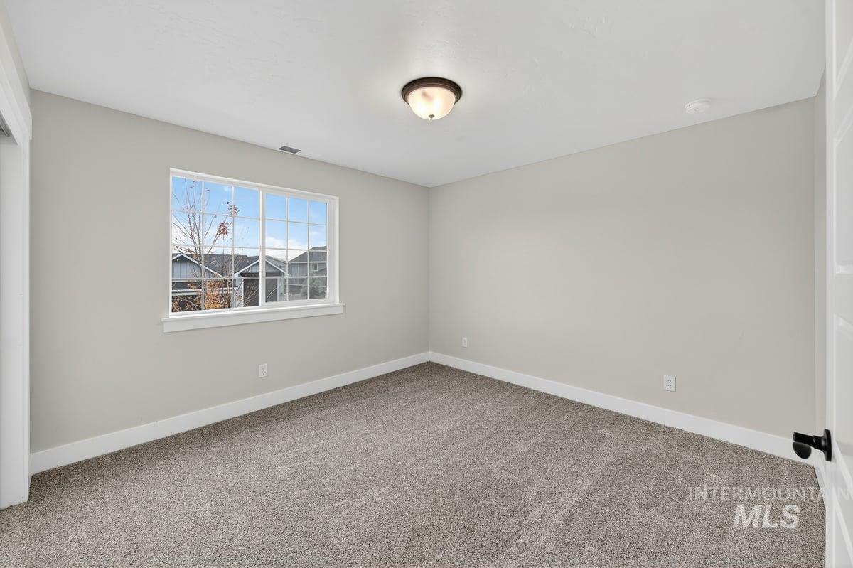 Unfurnished room with light carpet