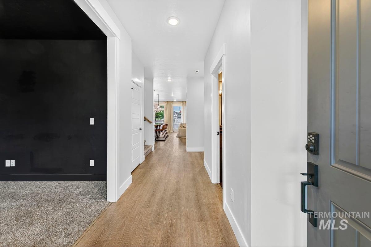 Hall featuring light wood-style flooring and recessed lighting
