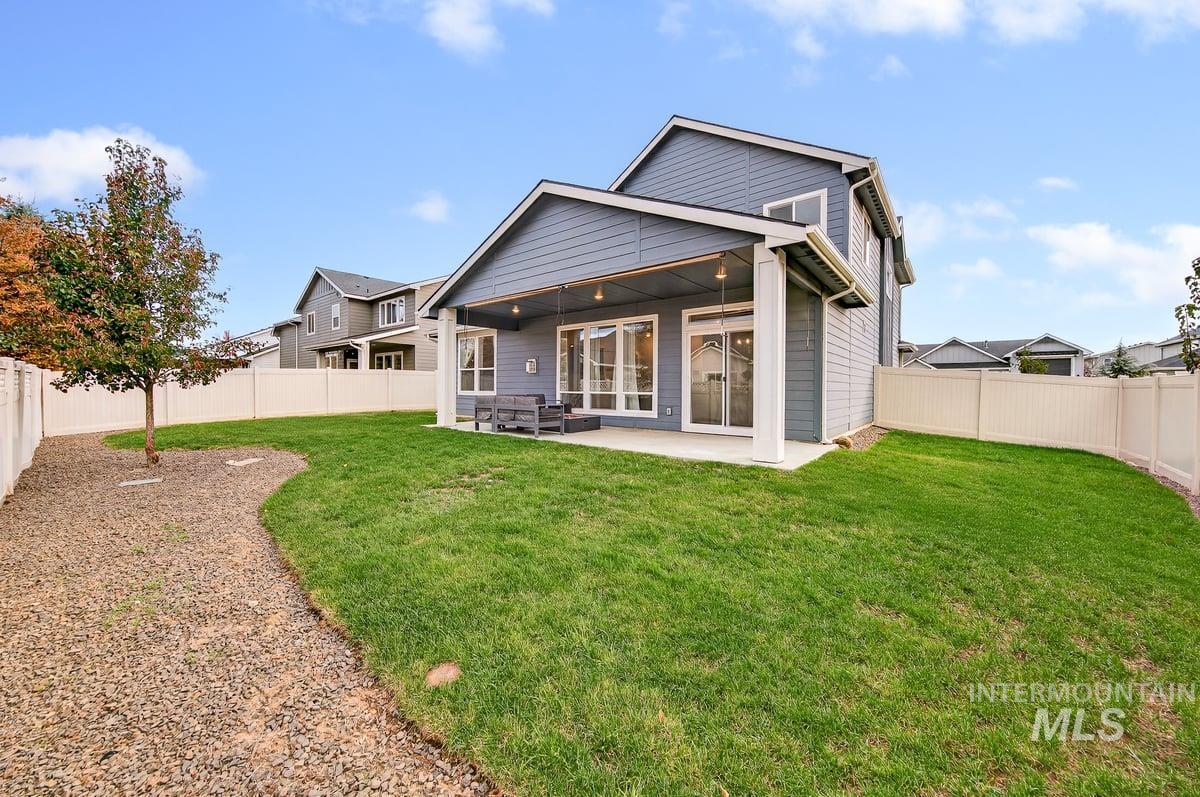 Rear view of property featuring a patio and a fenced backyard