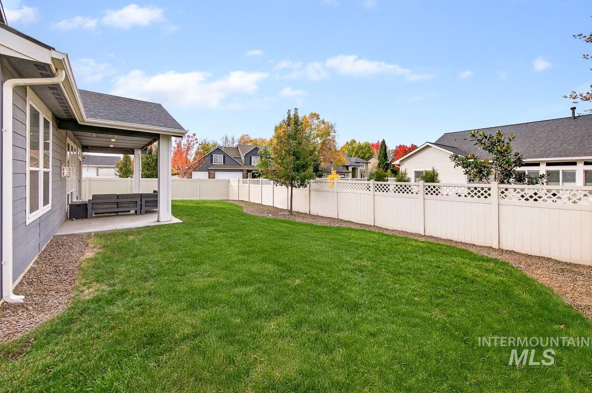 Fenced backyard with a patio and a residential view