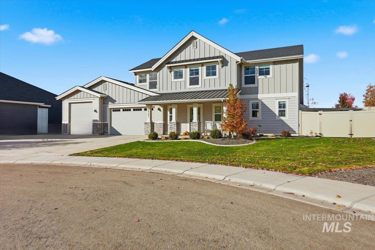 Craftsman-style home featuring a porch, board and batten siding, concrete driveway, and a garage