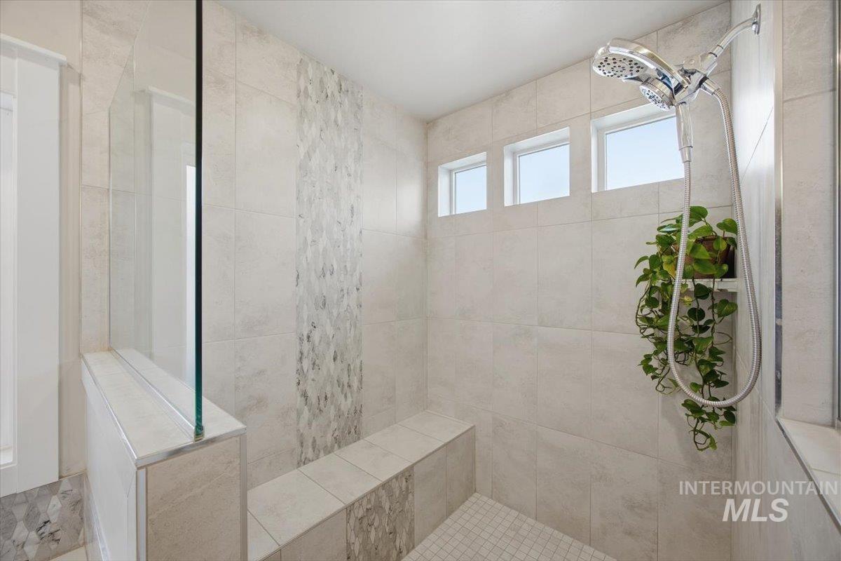Bathroom featuring a tile shower
