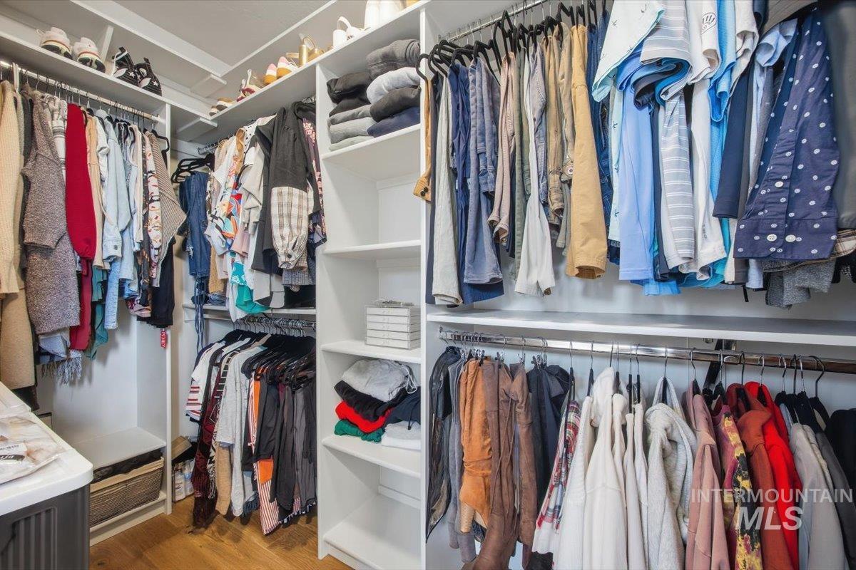 Spacious closet with dark wood-style flooring