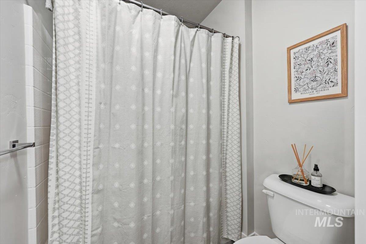 Bathroom featuring curtained shower