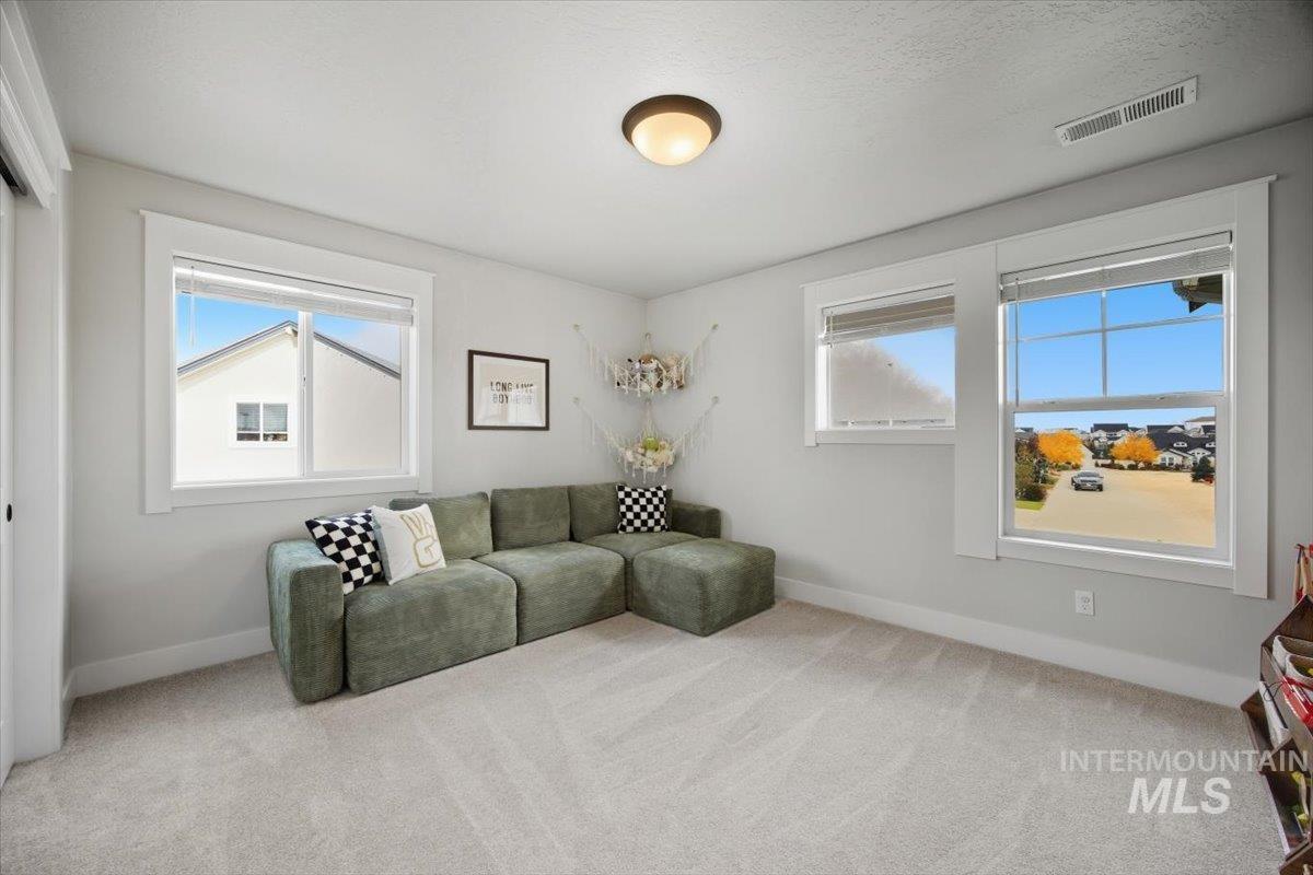 Carpeted living room with baseboards