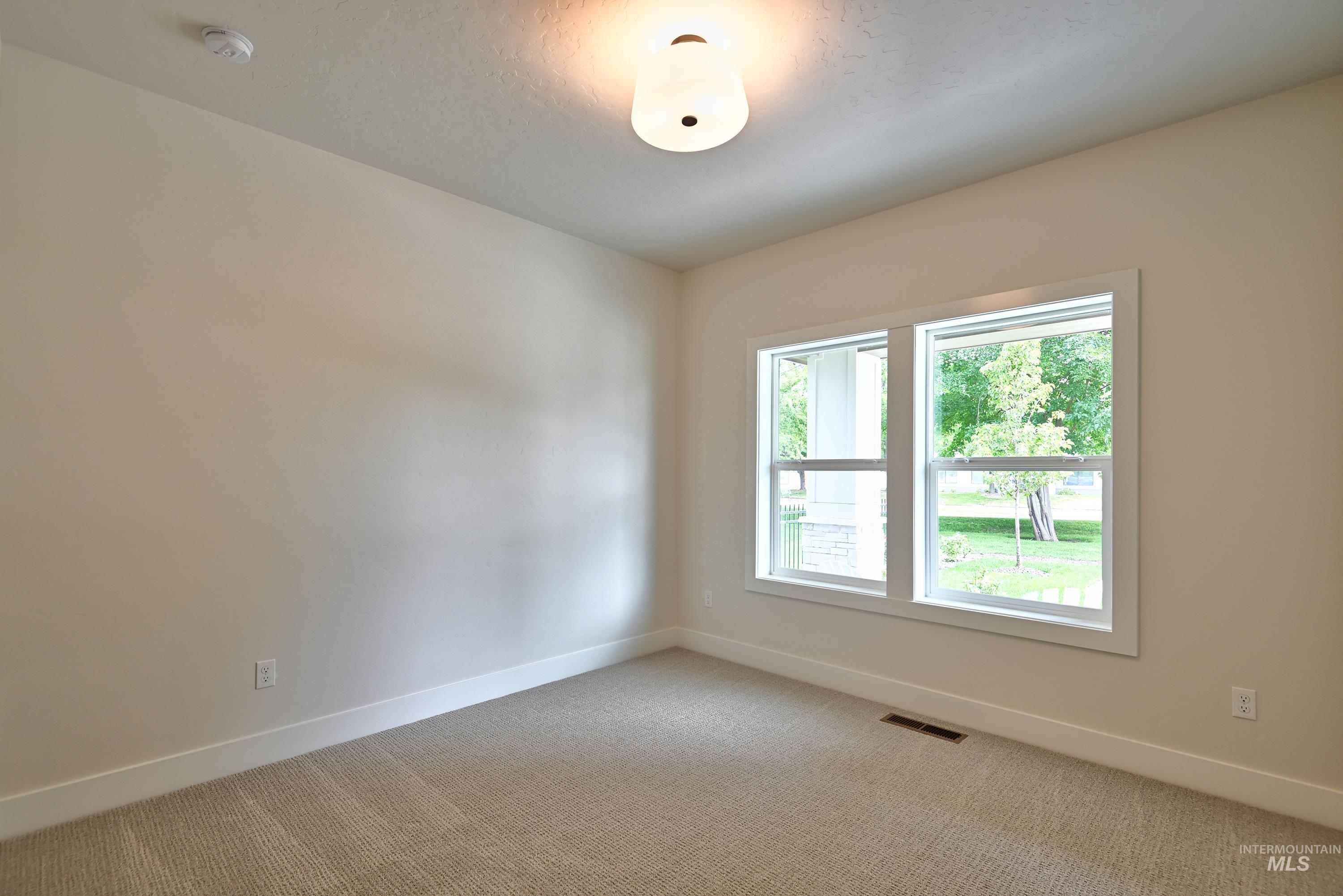 Unfurnished bedroom featuring baseboards and light colored carpet