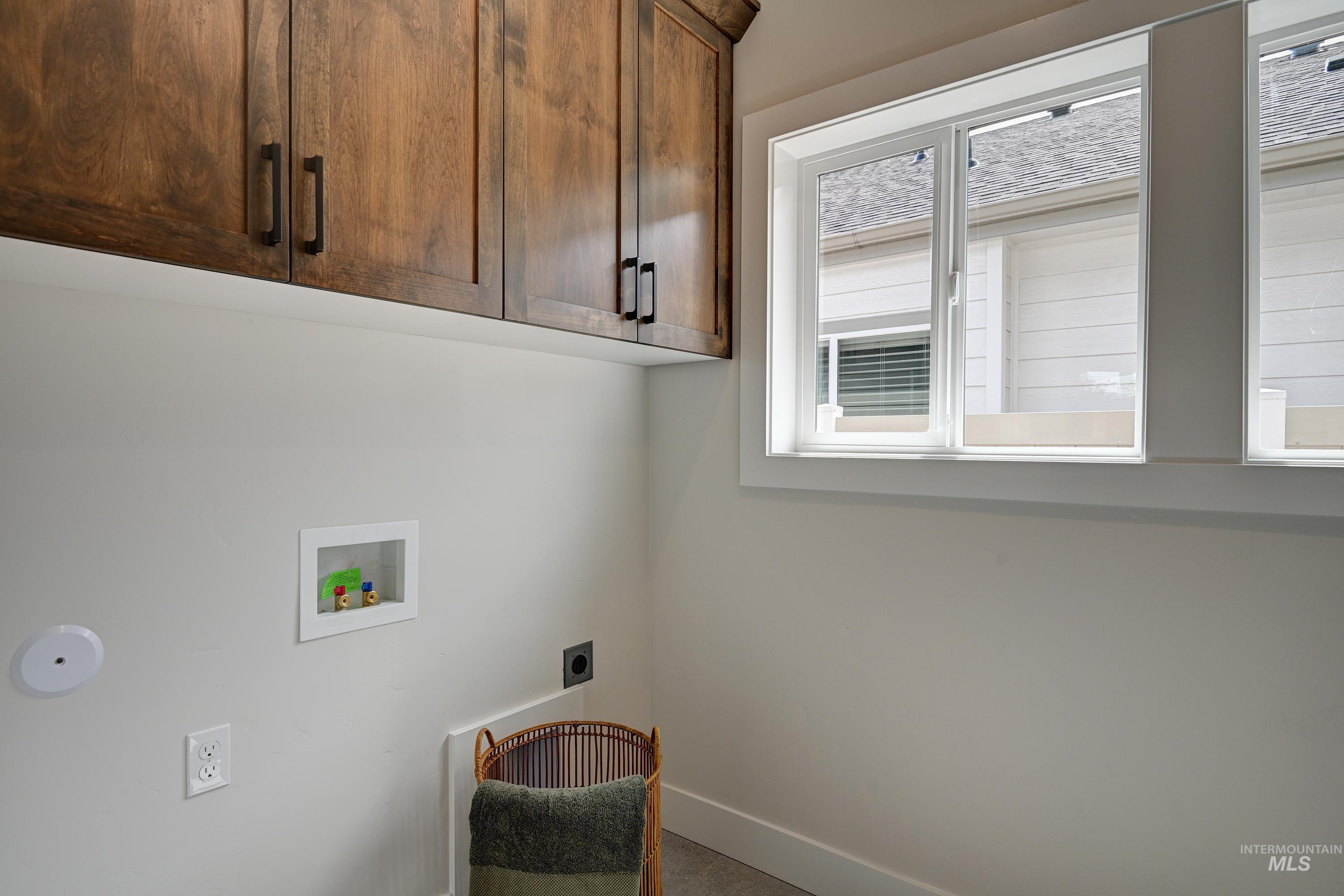 Laundry area featuring cabinet space, washer hookup, and electric dryer hookup